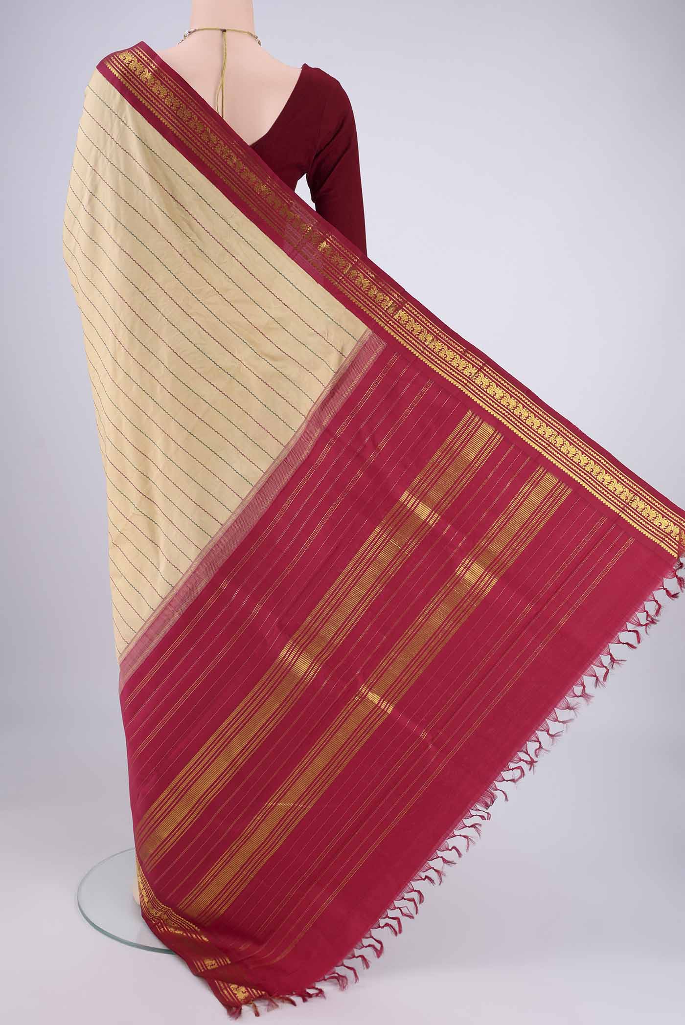 Flat view of Beige Kanchipuram Silk Saree with Veldhari on the body and Zari Border. 