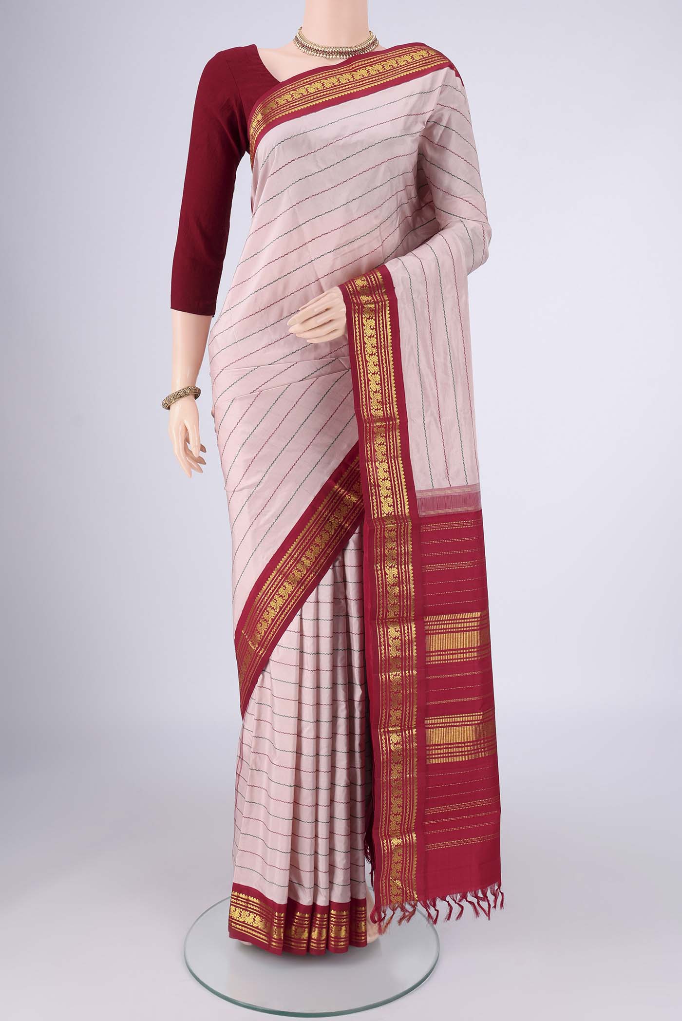 Rose pink Kanchipuram Silk Saree with Veldhari on the body and Zari Border.  displayed on a mannequin