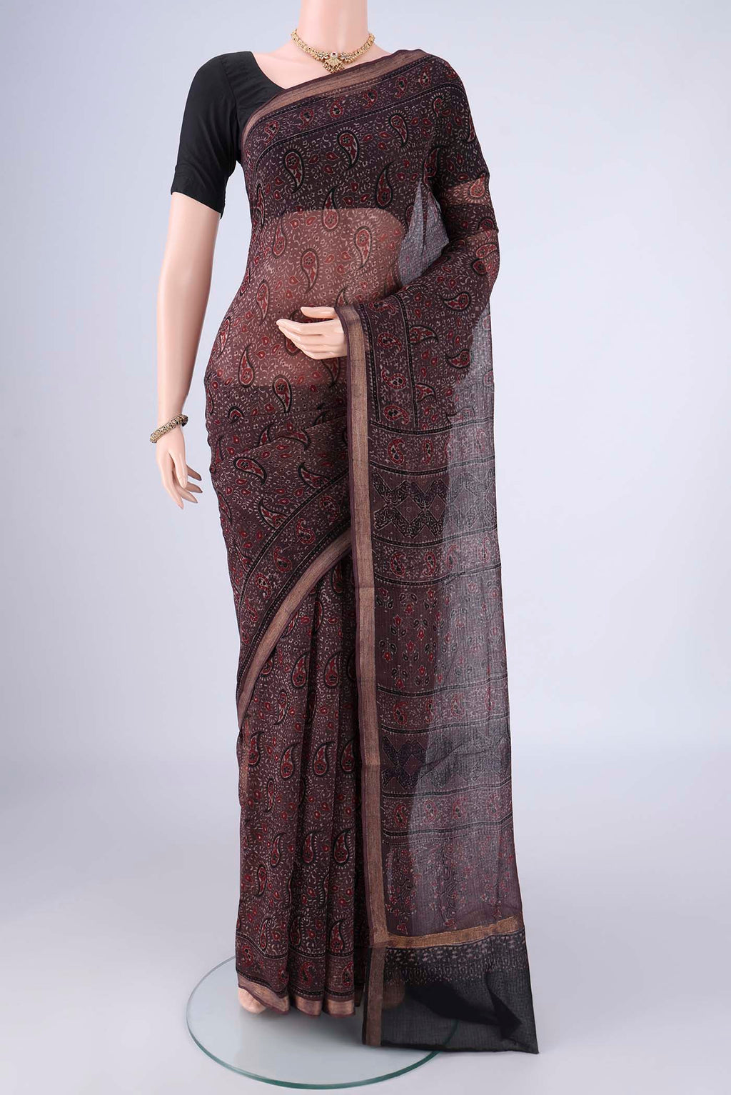 Burgundy Kota Cotton Saree with Ajrakh Print on the body and Zari Border.  displayed on a mannequin