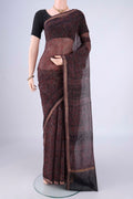 Burgundy Kota Cotton Saree with Ajrakh Print on the body and Zari Border.  displayed on a mannequin