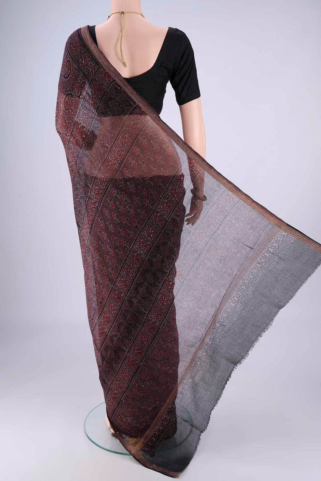 Flat view of Burgundy Kota Cotton Saree with Ajrakh Print on the body and Zari Border. 