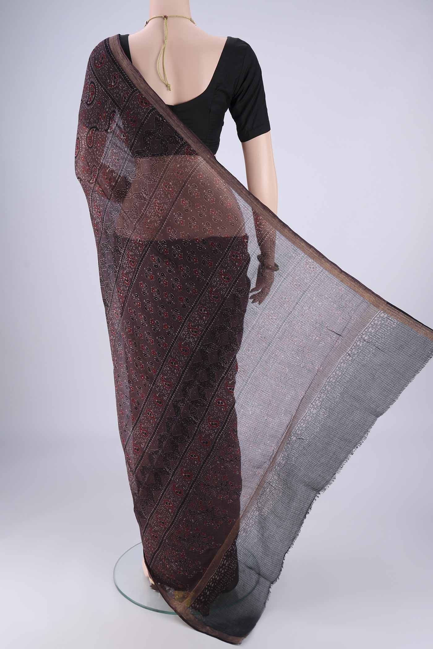 Flat view of Burgundy Kota Cotton Saree with Ajrakh Print on the body and Zari Border. 