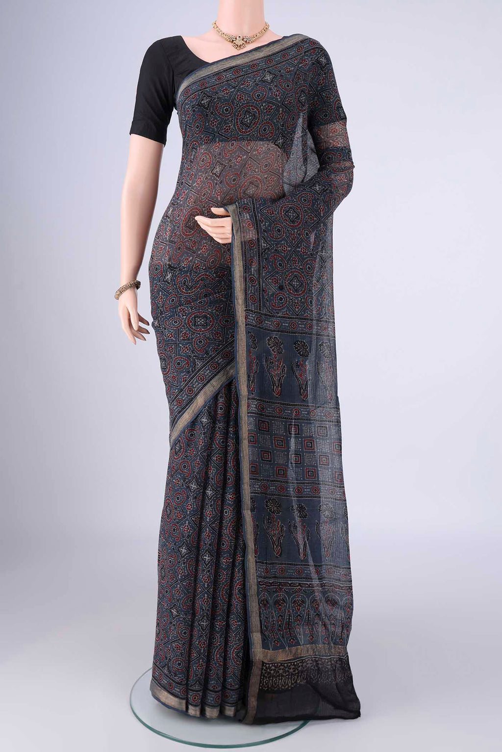 Indigo Kota Cotton Saree with Ajrakh Print on the body and Zari Border.  displayed on a mannequin