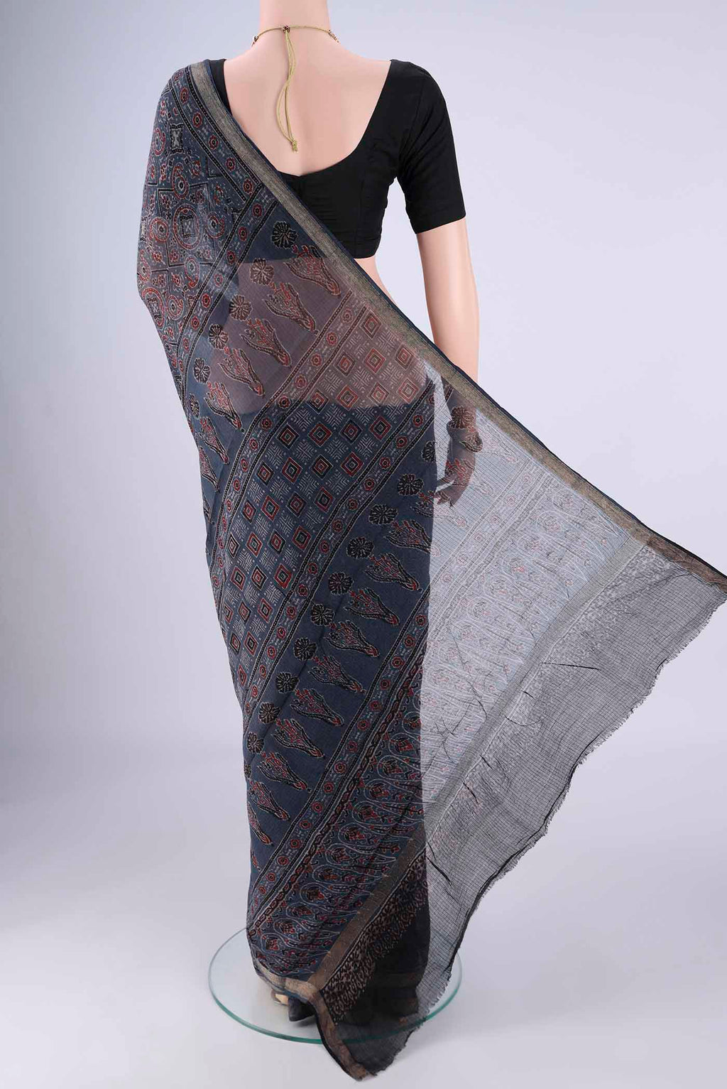 Flat view of Indigo Kota Cotton Saree with Ajrakh Print on the body and Zari Border. 