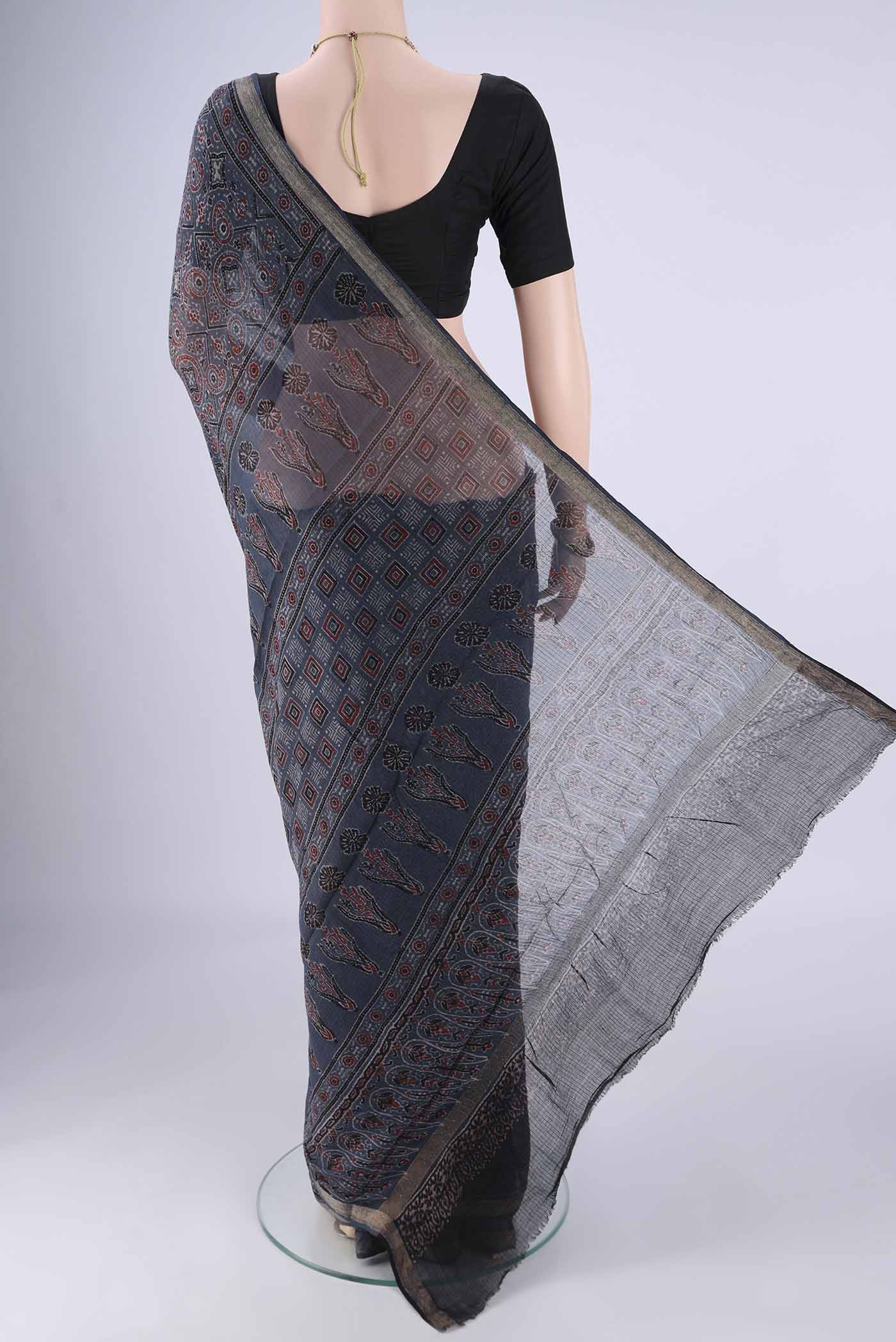 Flat view of Indigo Kota Cotton Saree with Ajrakh Print on the body and Zari Border. 