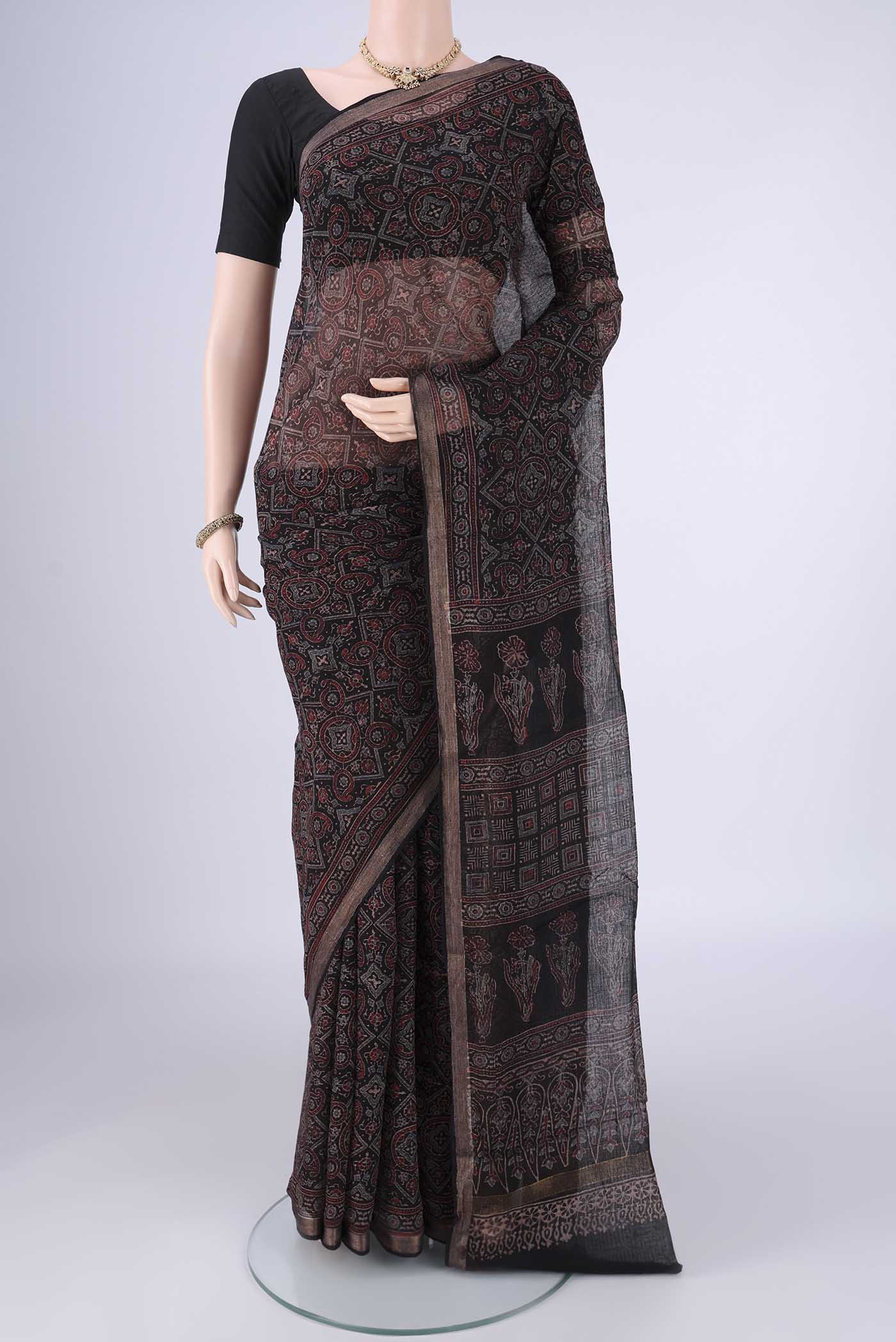 Black Kota Cotton Saree with Ajrakh Print on the body and Zari Border.  displayed on a mannequin