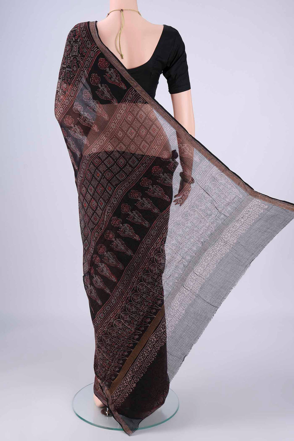 Flat view of Black Kota Cotton Saree with Ajrakh Print on the body and Zari Border. 