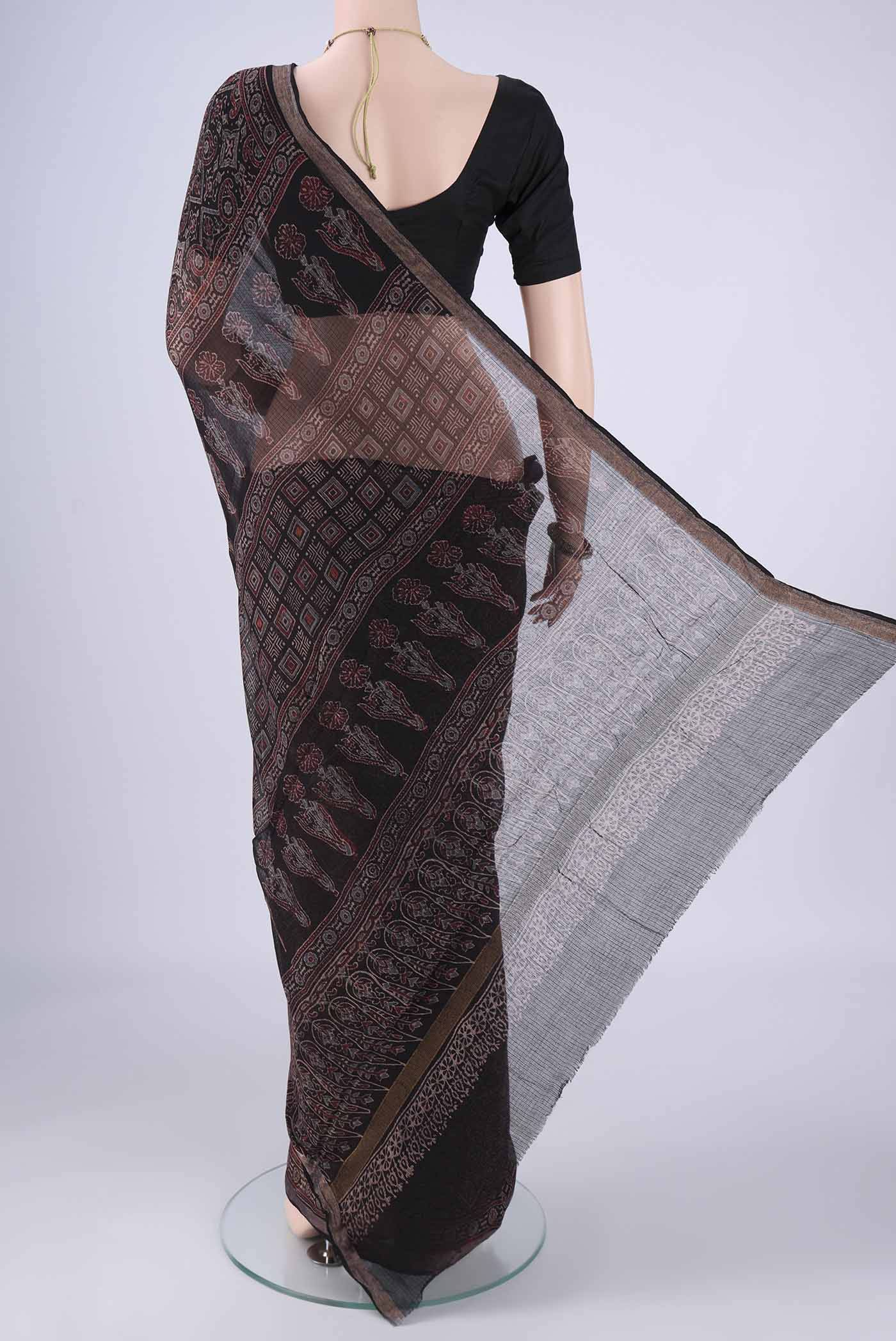 Flat view of Black Kota Cotton Saree with Ajrakh Print on the body and Zari Border. 