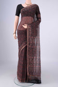 Burgundy Kota Cotton Saree with Ajrakh Print on the body and Zari Border.  displayed on a mannequin