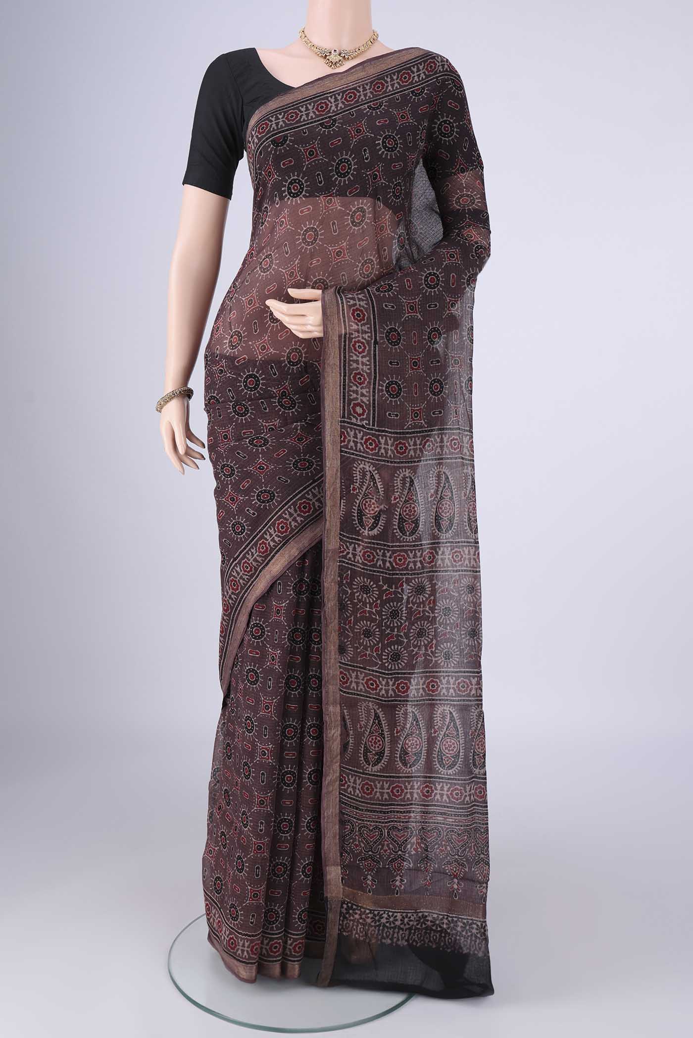 Burgundy Kota Cotton Saree with Ajrakh Print on the body and Zari Border.  displayed on a mannequin