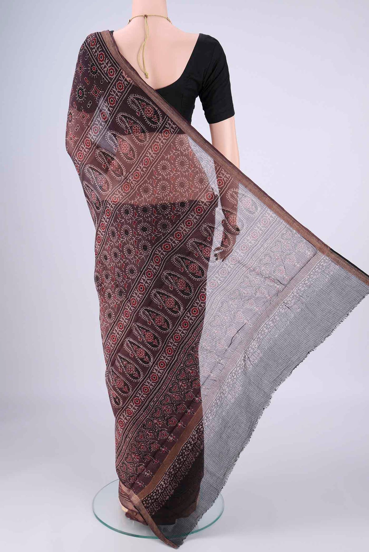 Flat view of Burgundy Kota Cotton Saree with Ajrakh Print on the body and Zari Border. 
