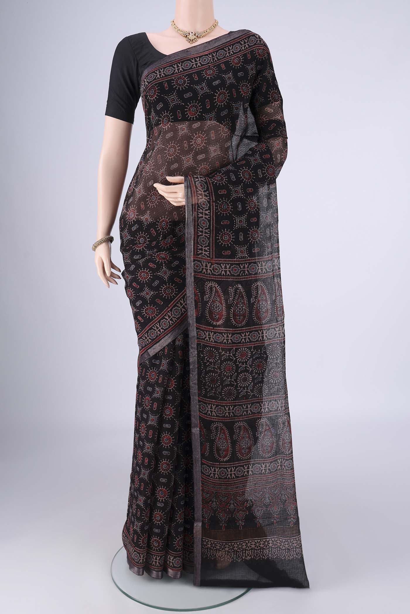 Black Kota Cotton Saree with Ajrakh Print on the body and Zari Border.  displayed on a mannequin