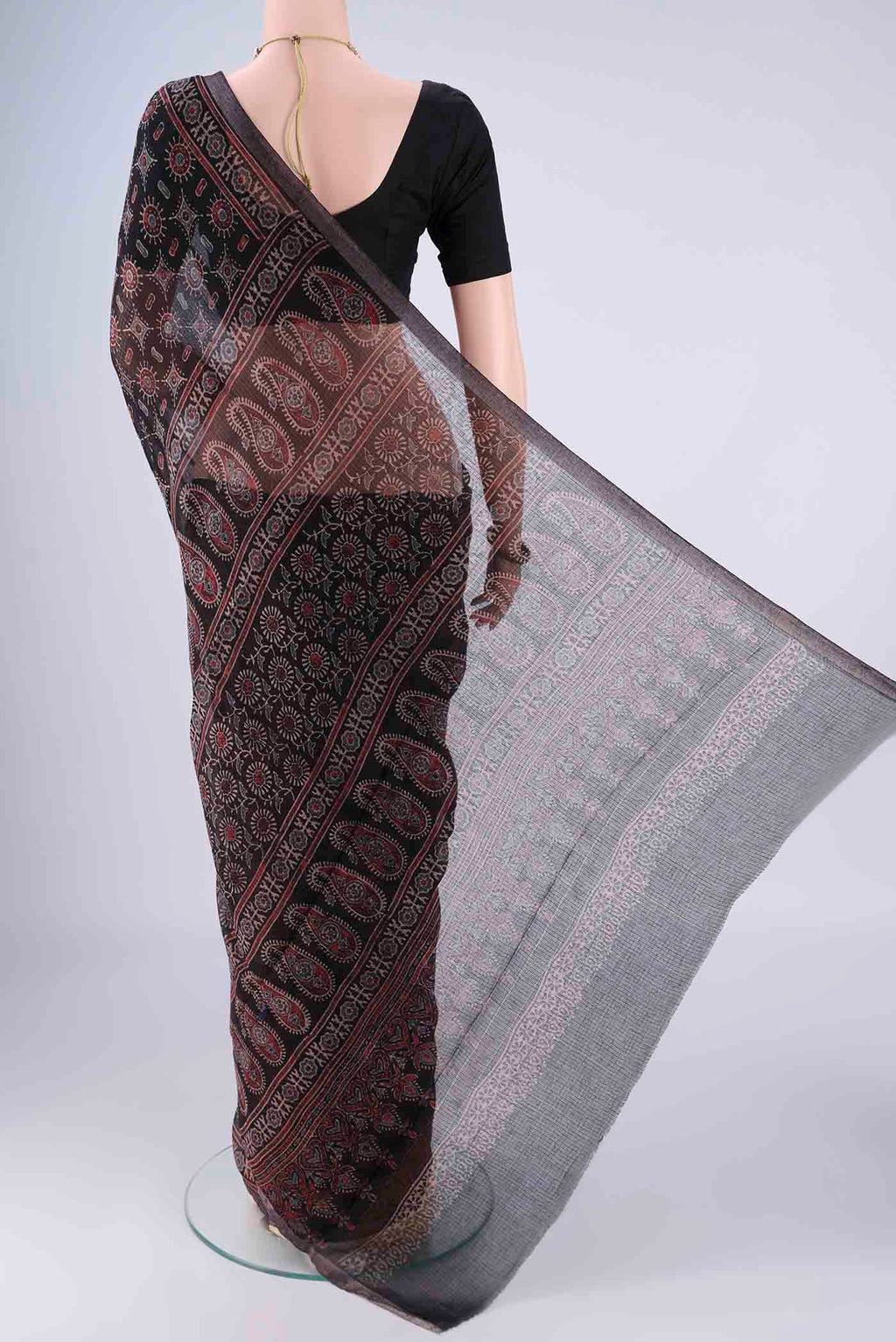 Flat view of Black Kota Cotton Saree with Ajrakh Print on the body and Zari Border. 