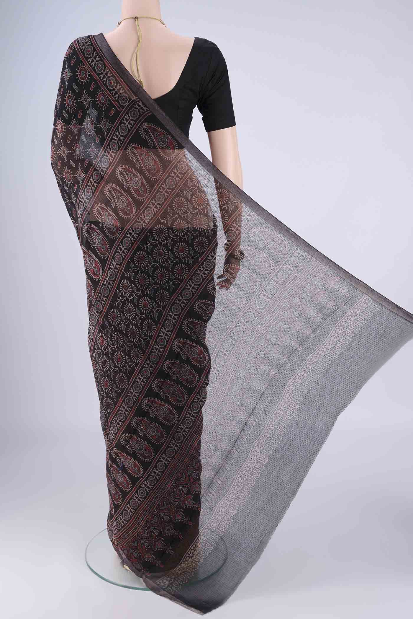 Flat view of Black Kota Cotton Saree with Ajrakh Print on the body and Zari Border. 