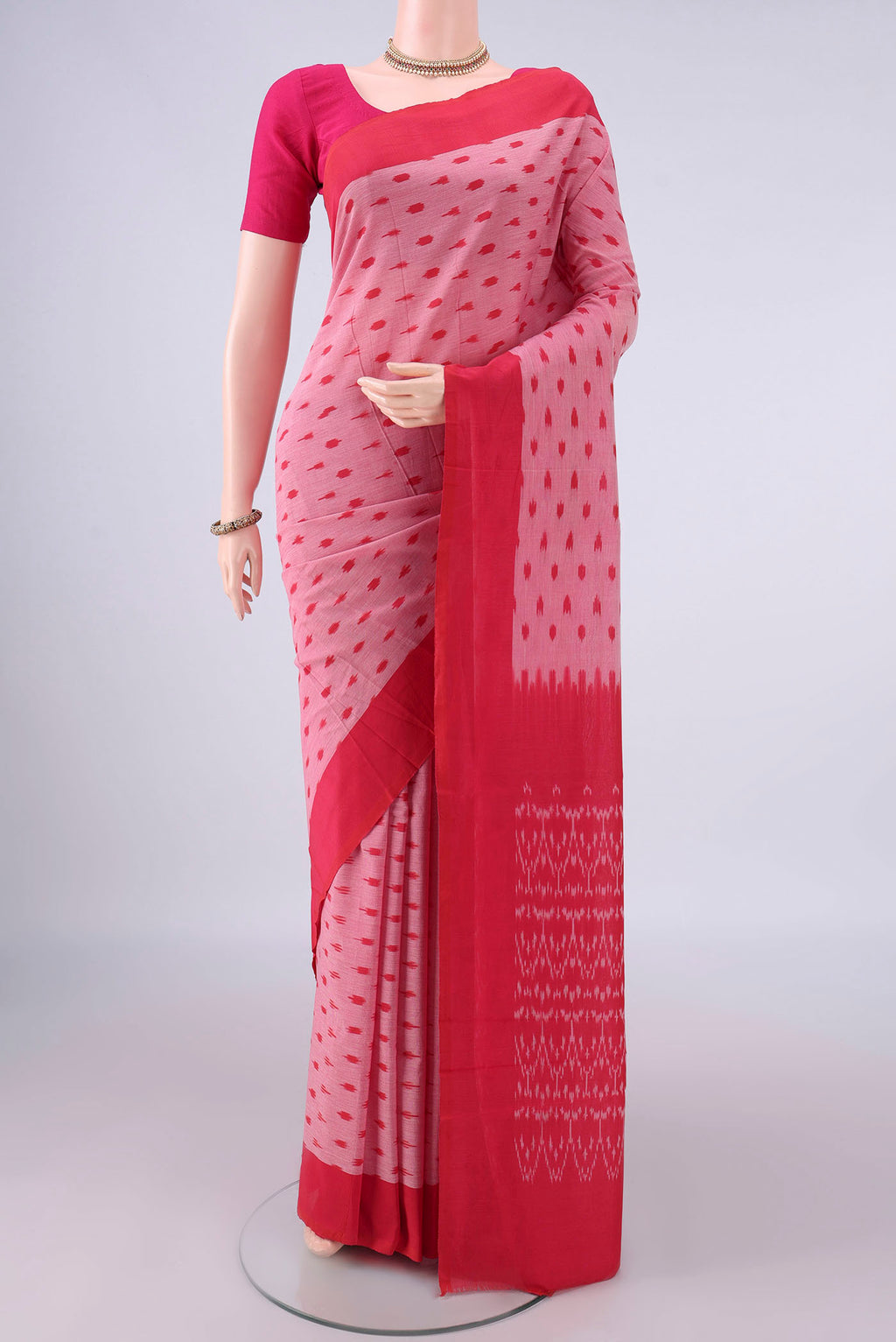 Rose pink Pochampally Cotton Saree with Ikat design on the body and Ikat Border.  displayed on a mannequin