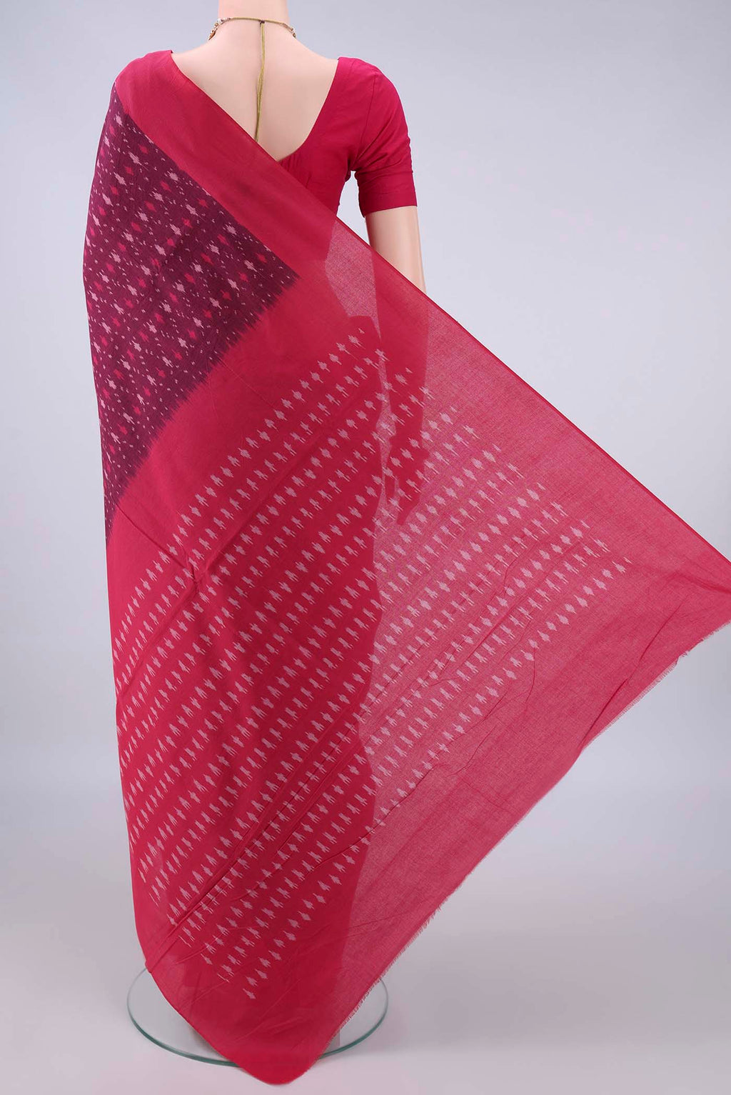 Flat view of Magenta Pochampally Cotton Saree with Ikat design on the body and Ikat Border. 