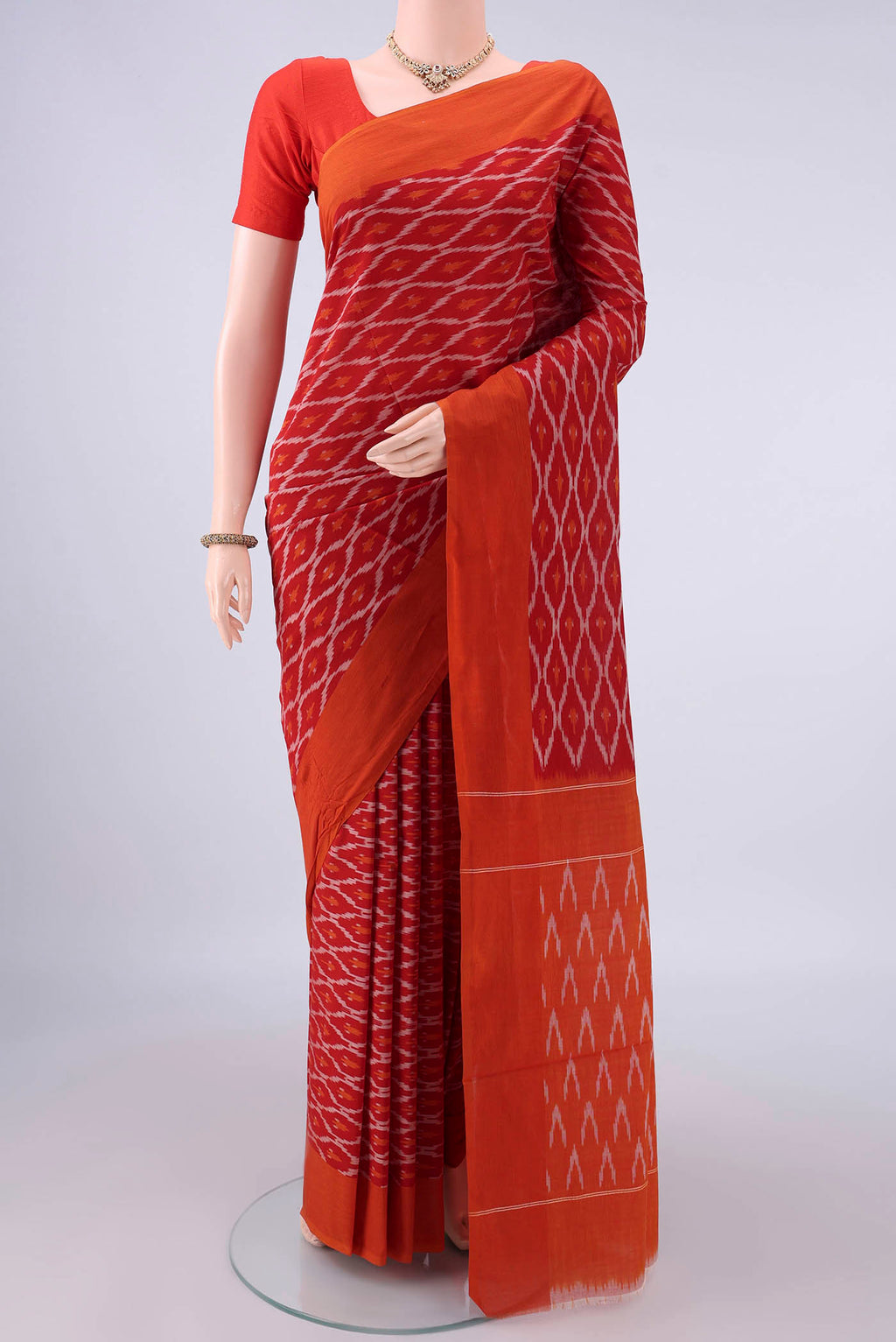 Red Pochampally Cotton Saree with Ikat design on the body and Ikat Border.  displayed on a mannequin