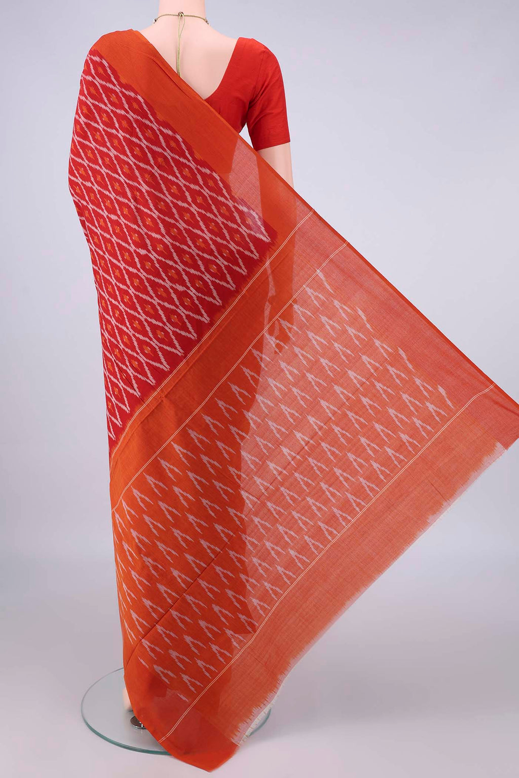 Flat view of Red Pochampally Cotton Saree with Ikat design on the body and Ikat Border. 