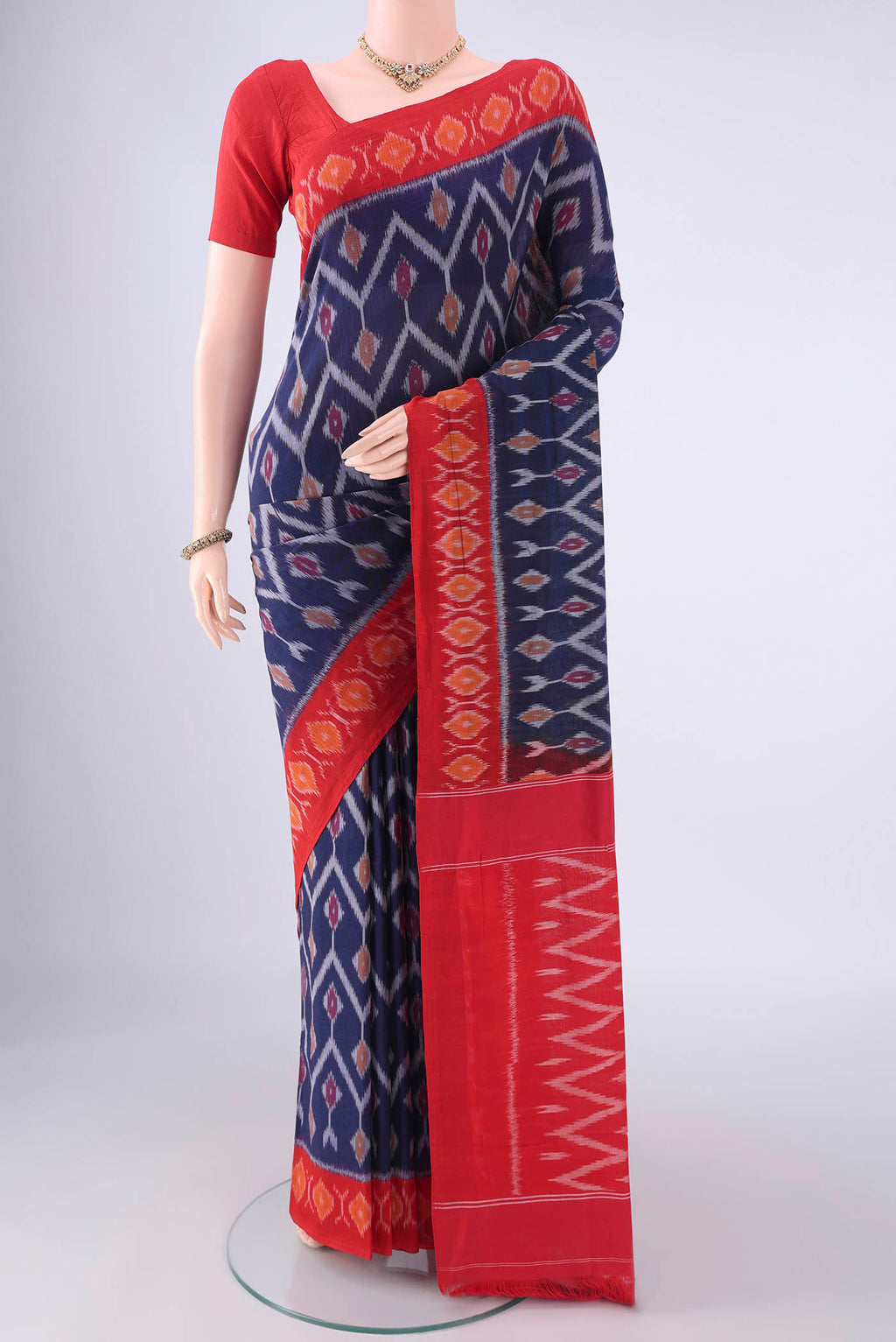 Navy Blue Pochampally Cotton Saree with Ikat design on the body and Ikat Border.  displayed on a mannequin