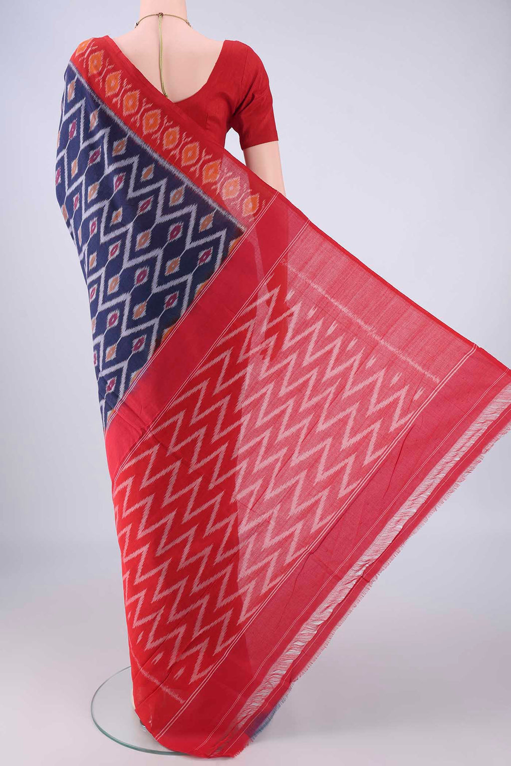 Flat view of Navy Blue Pochampally Cotton Saree with Ikat design on the body and Ikat Border. 