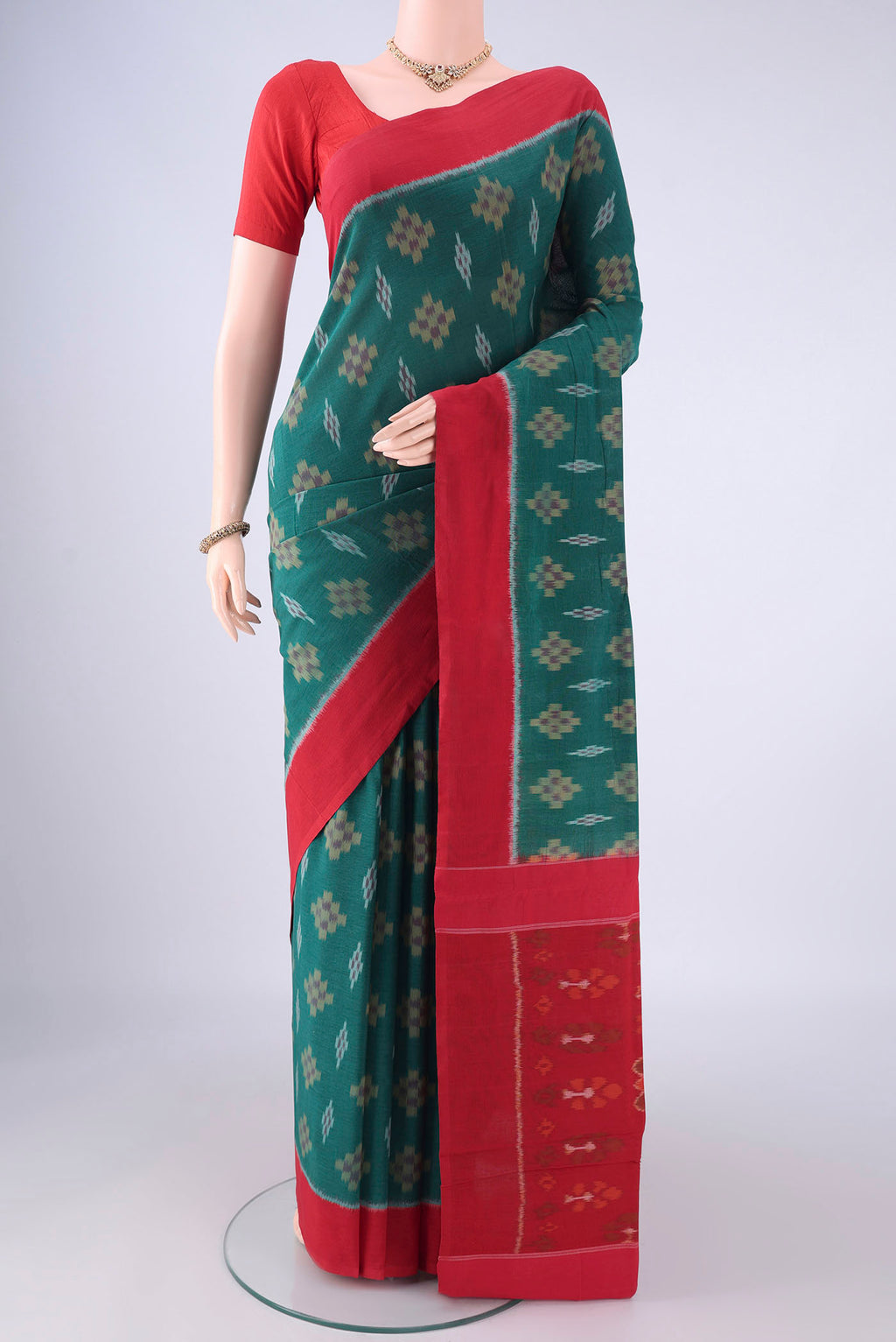 Green Pochampally Cotton Saree with Ikat design on the body and Plain Border.  displayed on a mannequin