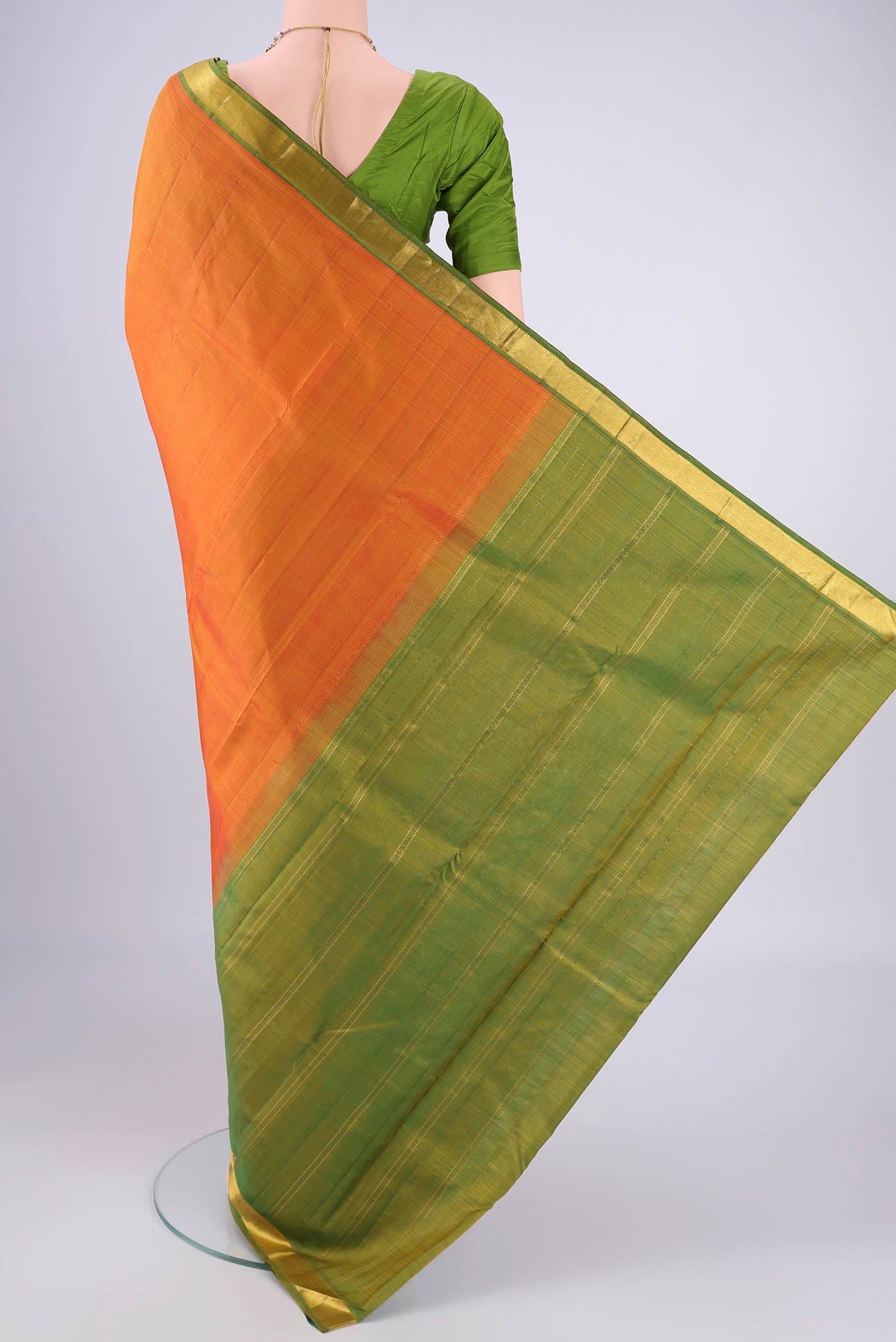 Flat view of Brick Orange Kanjivaram Silk Saree with Plain Body and Zari Border. 
