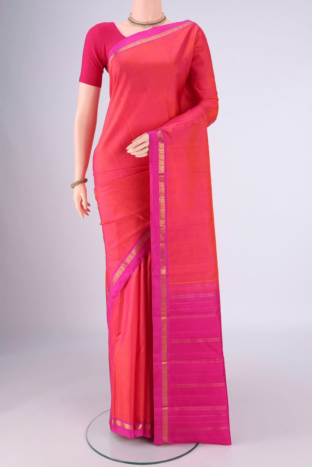 Pink with Orange Color Kanjivaram Silk Saree with Plain Body and Zari Border.  displayed on a mannequin