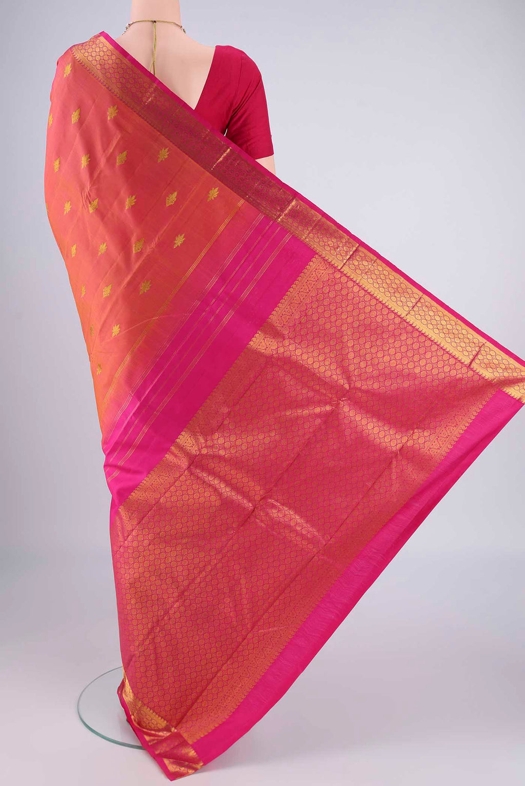 Flat view of Pinkish Yellow Dual Tone Kanchipuram Silk Saree with Zari Butta on the body and Zari Border. 