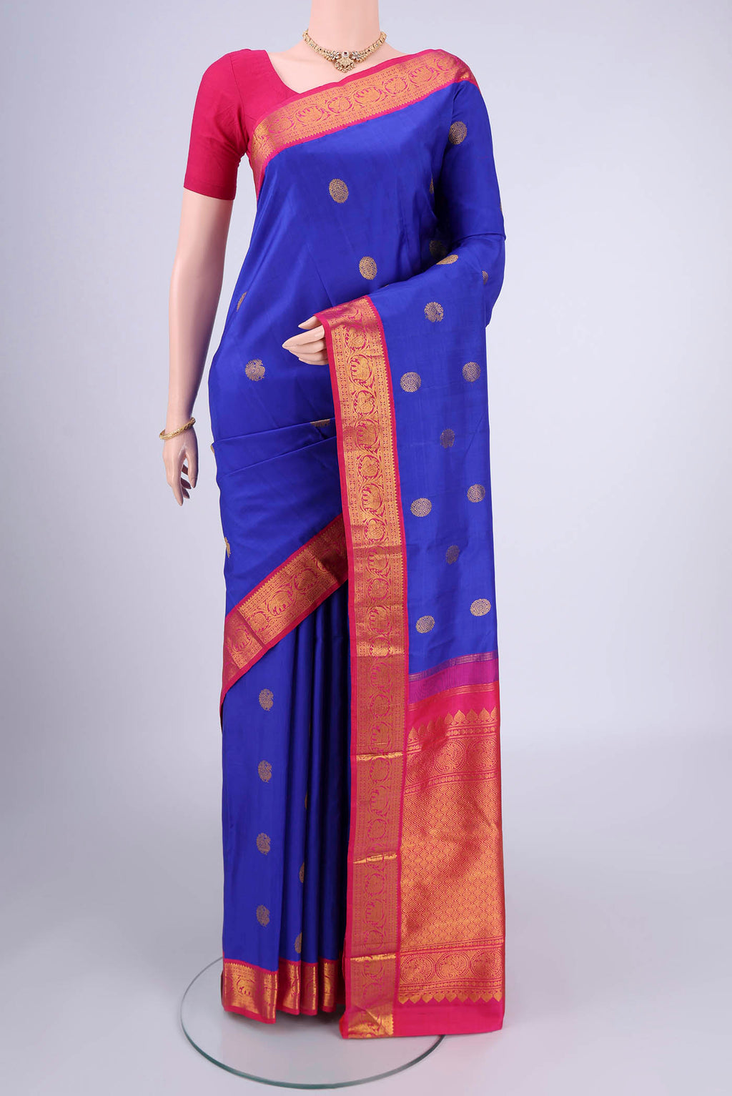 Royal Blue Kanjivaram Silk Saree with Zari Butta on the body and Zari Border.  displayed on a mannequin
