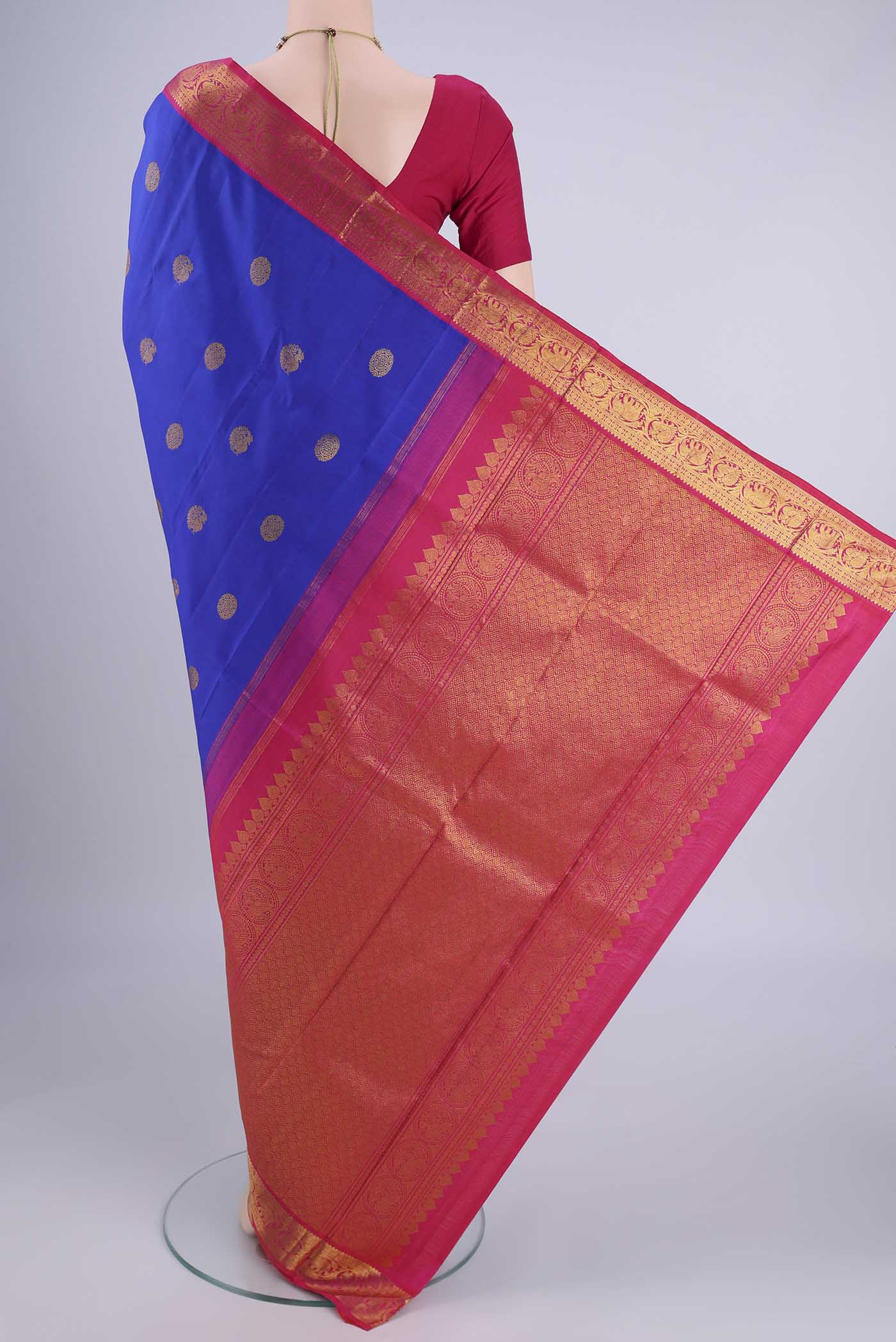 Flat view of Royal Blue Kanjivaram Silk Saree with Zari Butta on the body and Zari Border. 