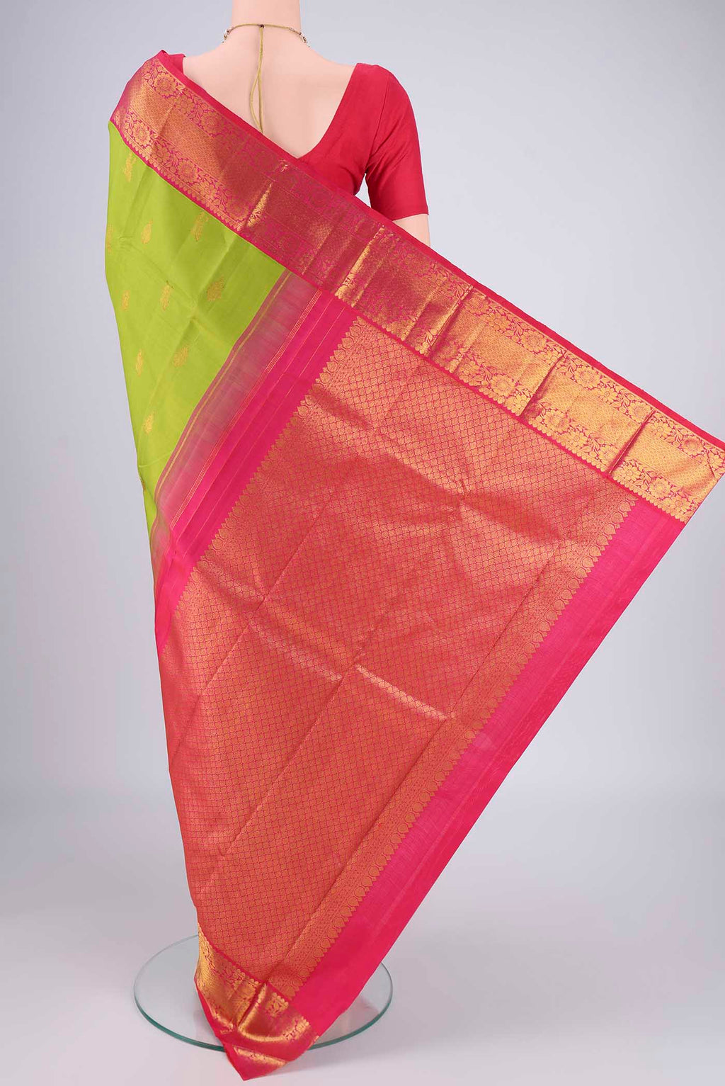 Flat view of Green Kanjivaram Silk Saree with Zari Butta on the body and Zari Border. 