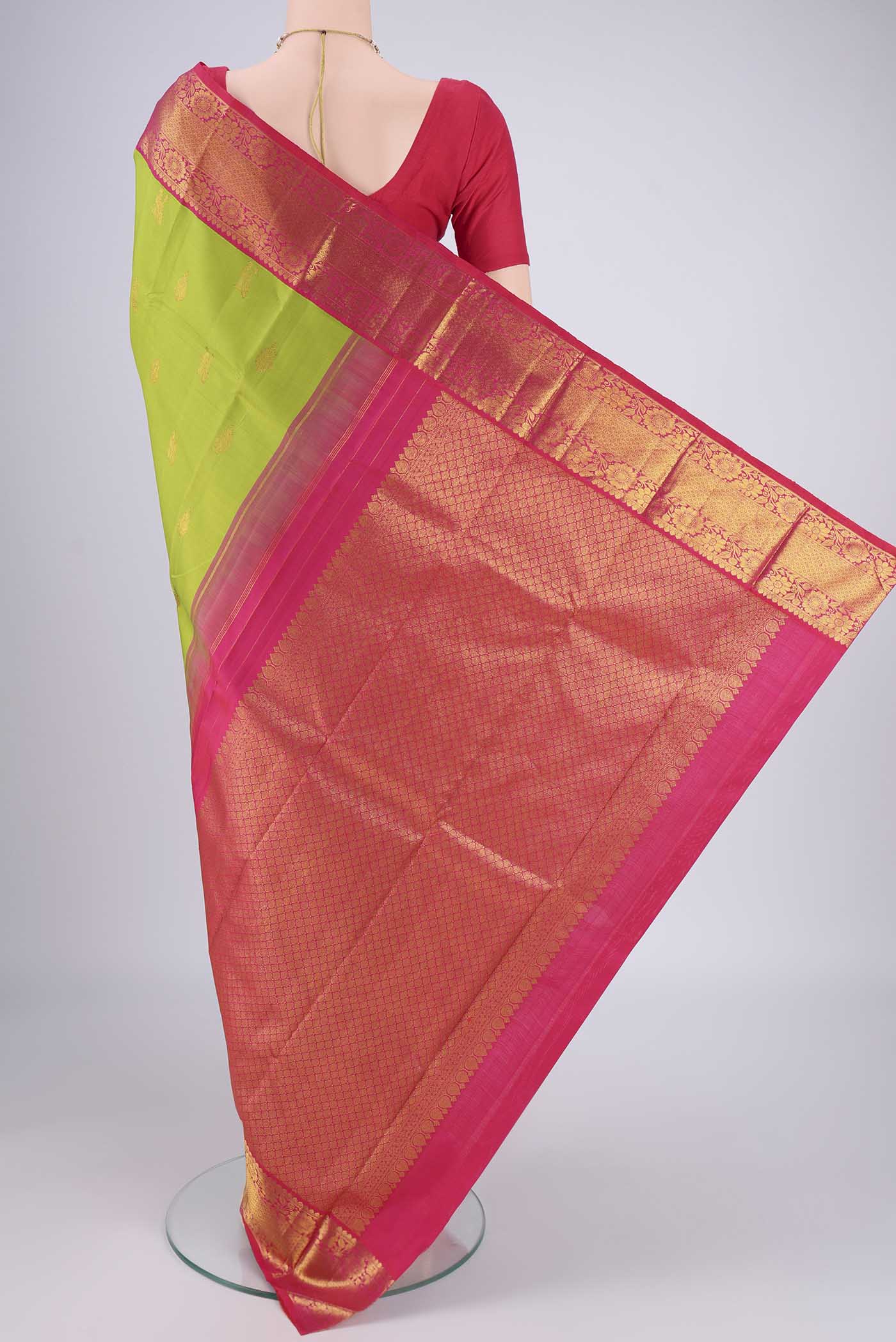 Flat view of Green Kanjivaram Silk Saree with Zari Butta on the body and Zari Border. 