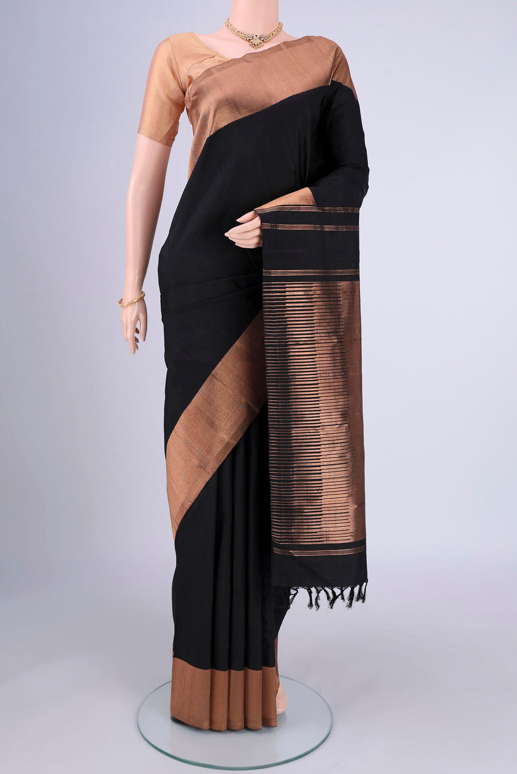 Black Kanjivaram Silk Saree with Plain Body and Zari Border.  displayed on a mannequin