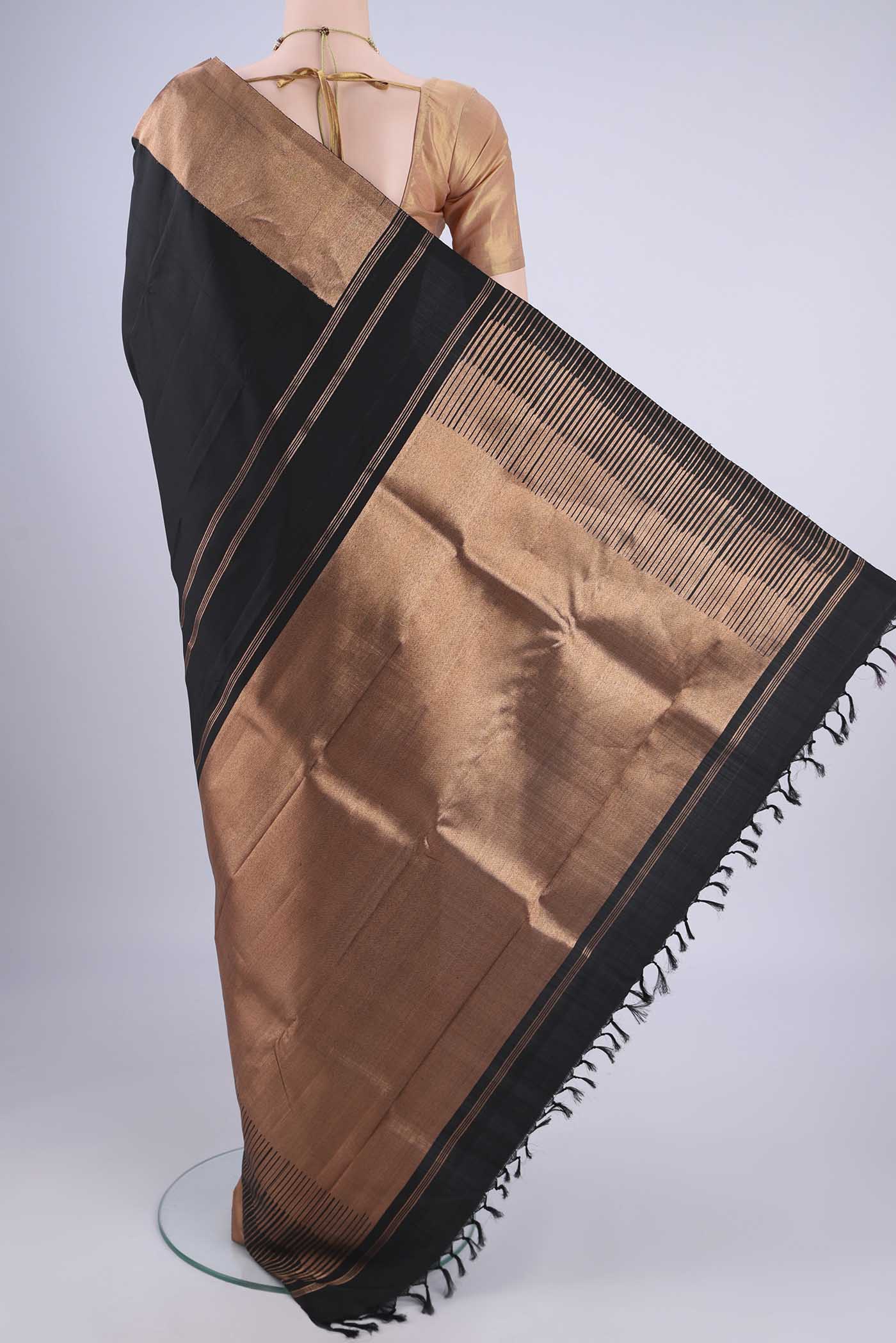 Flat view of Black Kanjivaram Silk Saree with Plain Body and Zari Border. 