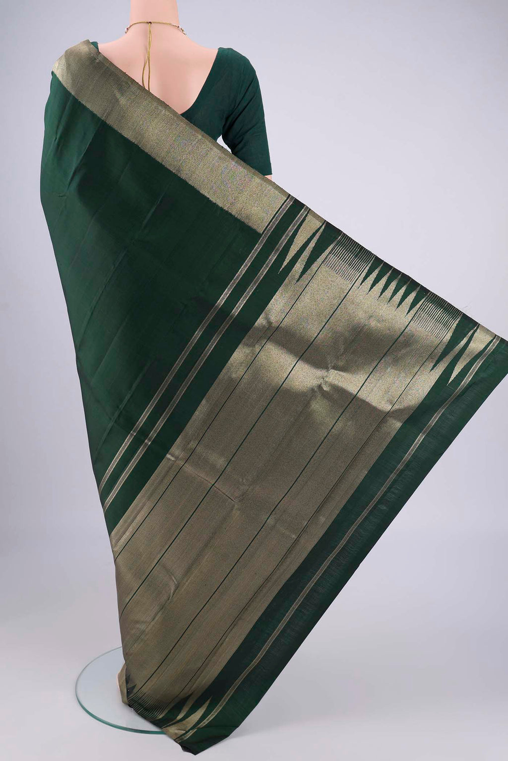 Flat view of Bottle Green Kanjivaram Silk Saree with Plain Body and Zari Border. 