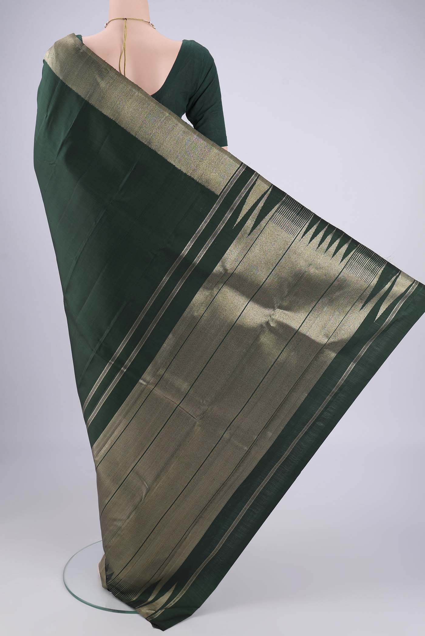 Flat view of Bottle Green Kanjivaram Silk Saree with Plain Body and Zari Border. 