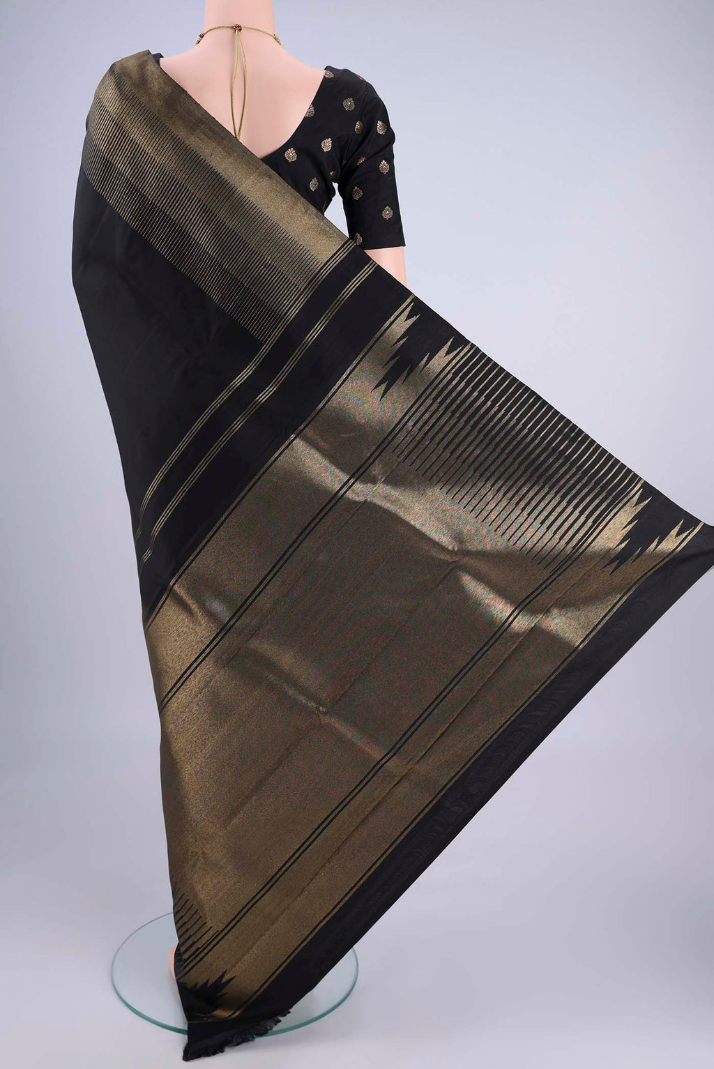 Flat view of Black Kanchipuram Silk Saree with Zari Butta on the body and Zari Border. 