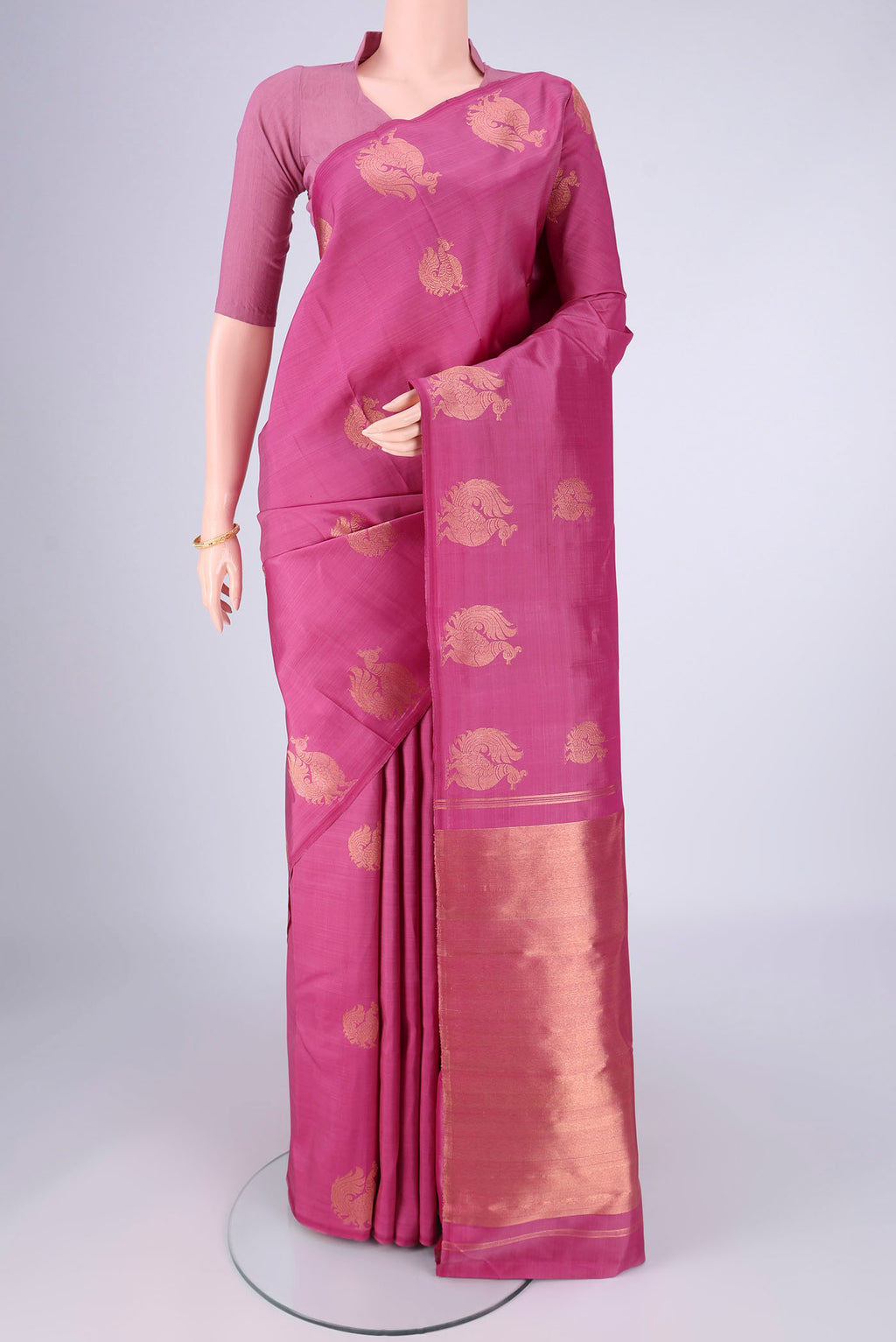 Pink Kanchipuram Silk Saree with Zari Butta on the body and Without Border.  displayed on a mannequin