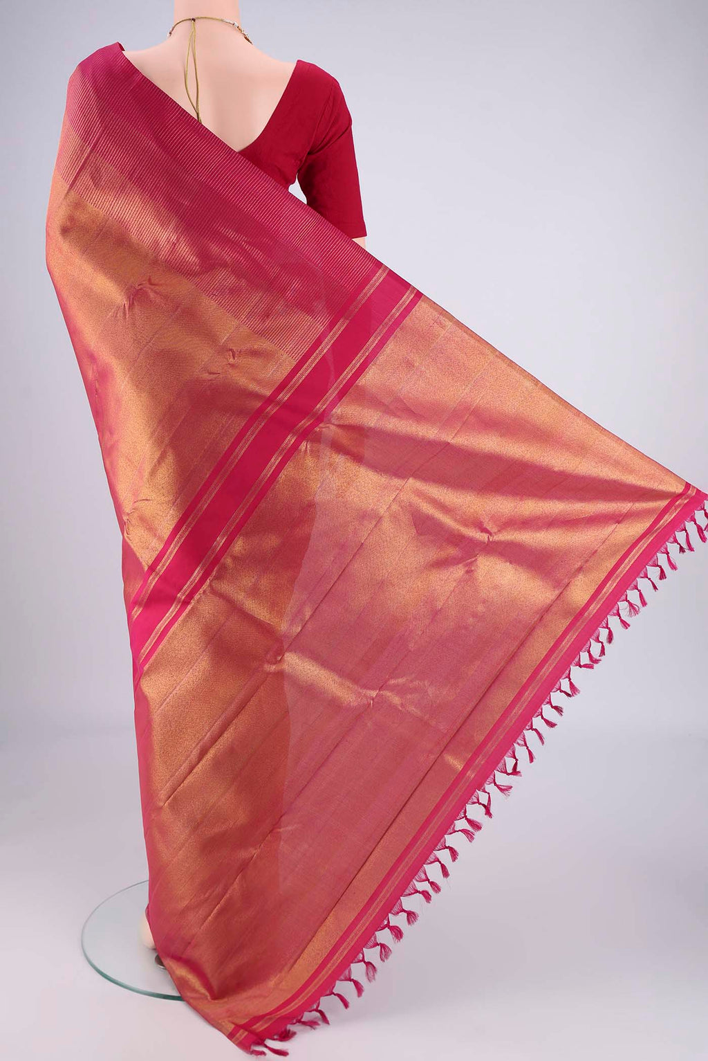 Flat view of Rani Pink Kanchipuram Silk Saree with Zari Brocade on the body and Zari Border. 