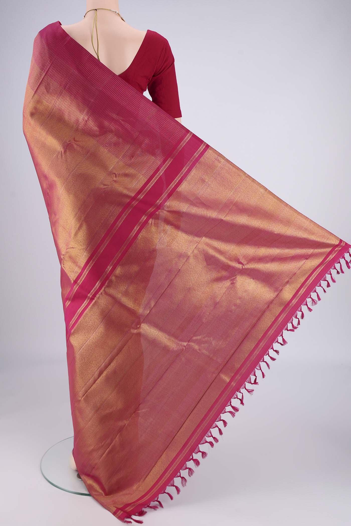 Flat view of Rani Pink Kanchipuram Silk Saree with Zari Brocade on the body and Zari Border. 