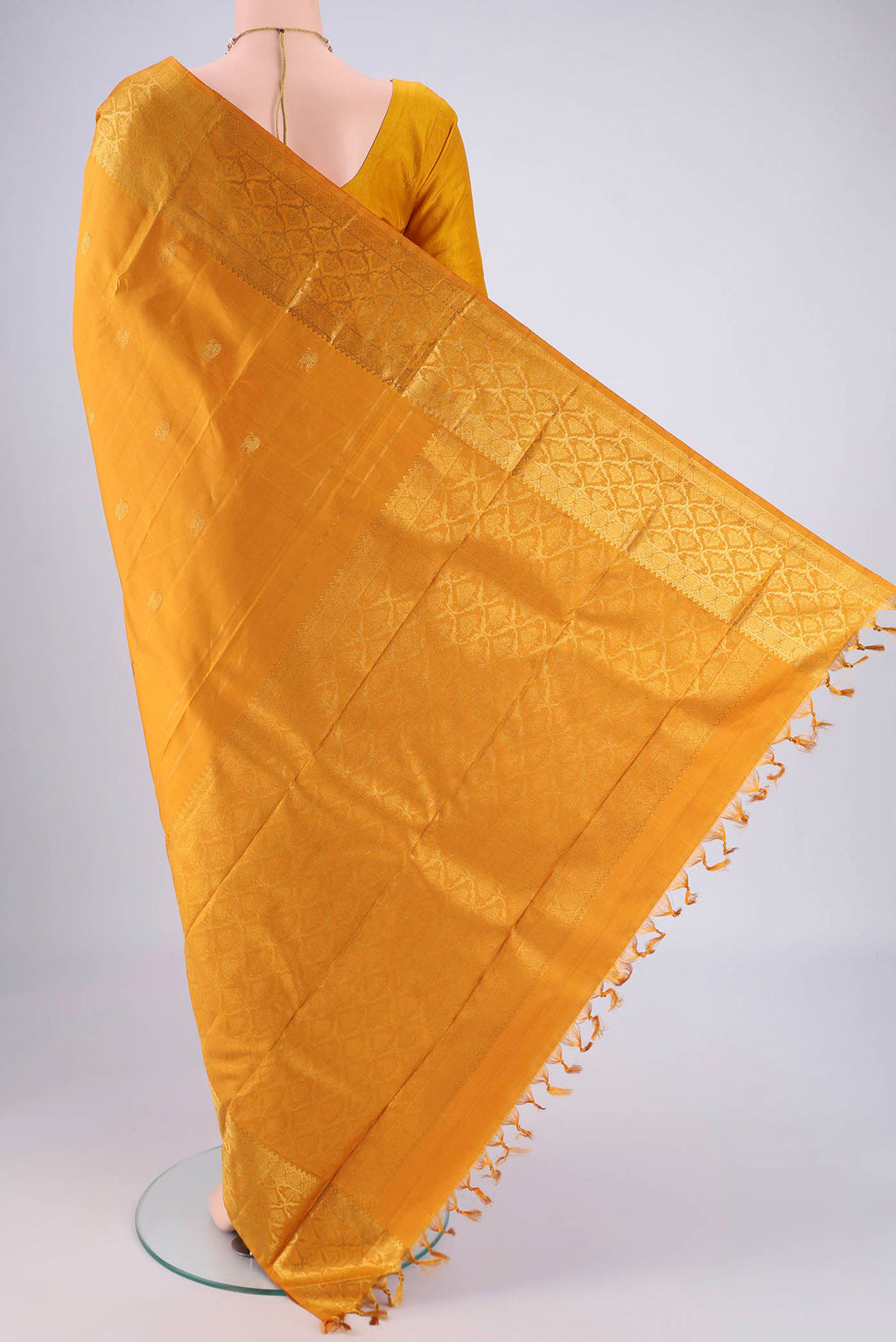 Flat view of Mustard Kanjivaram Silk Saree with Zari Butta on the body and Zari Border. 