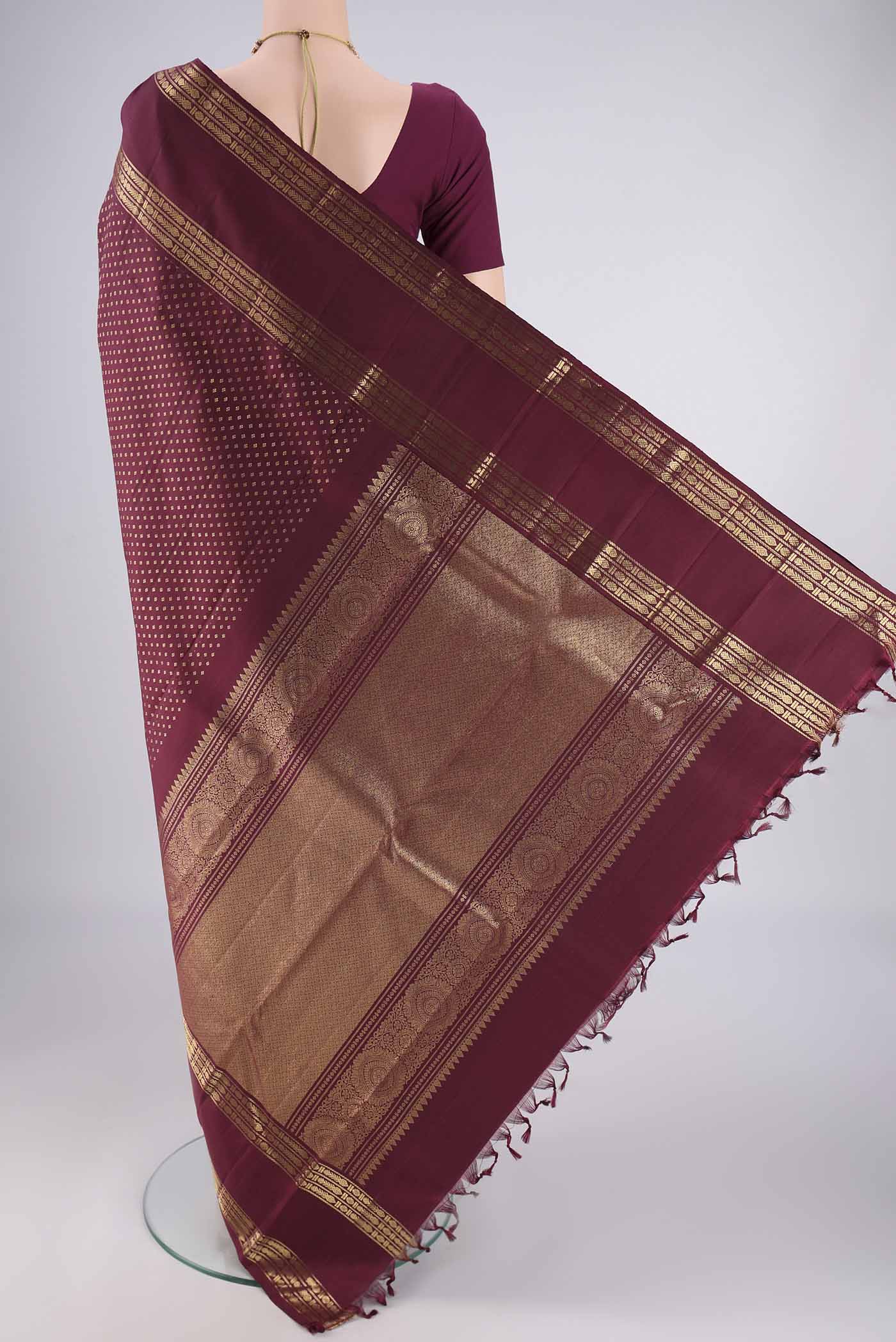 Flat view of Pure Silk Pure Zari Maroon Kanjivaram Saree with Zari Butta on the body and Zari Border. 