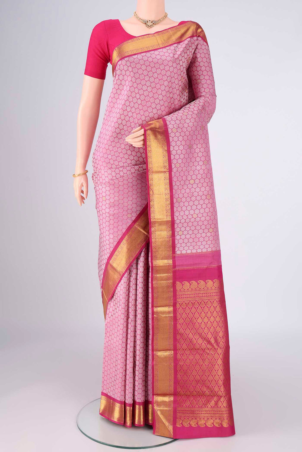 Rose pink Kanjivaram Silk Saree with Jacquard With Zari Butta on the body and Zari Border.  displayed on a mannequin