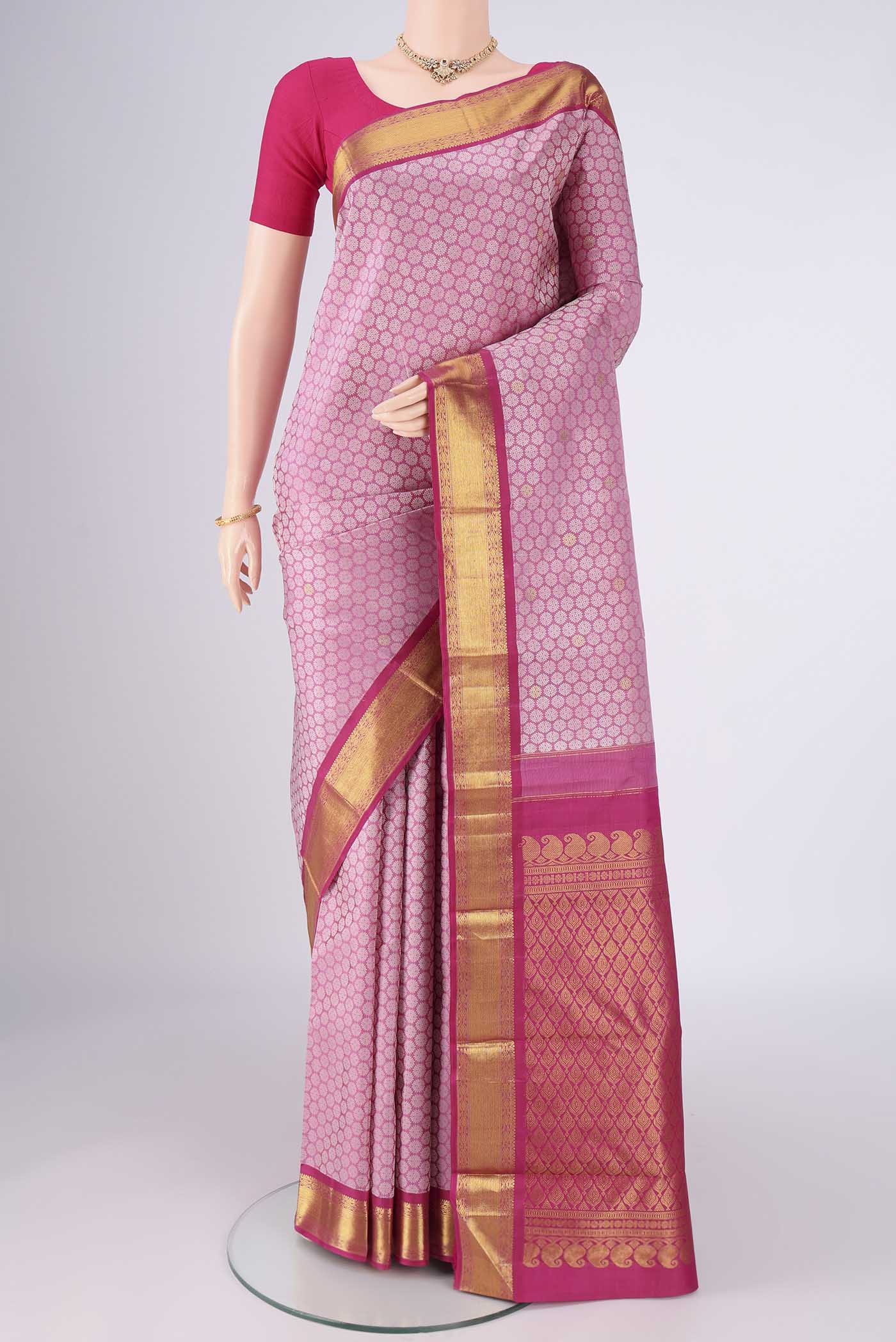Rose pink Kanjivaram Silk Saree with Jacquard With Zari Butta on the body and Zari Border.  displayed on a mannequin