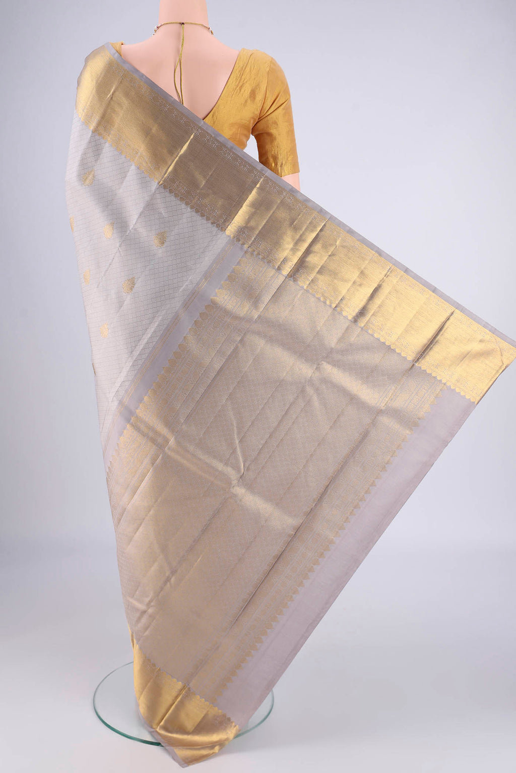Flat view of Grey Kanjivaram Silk Saree with Jacquard With Zari Butta on the body and Zari Border. 