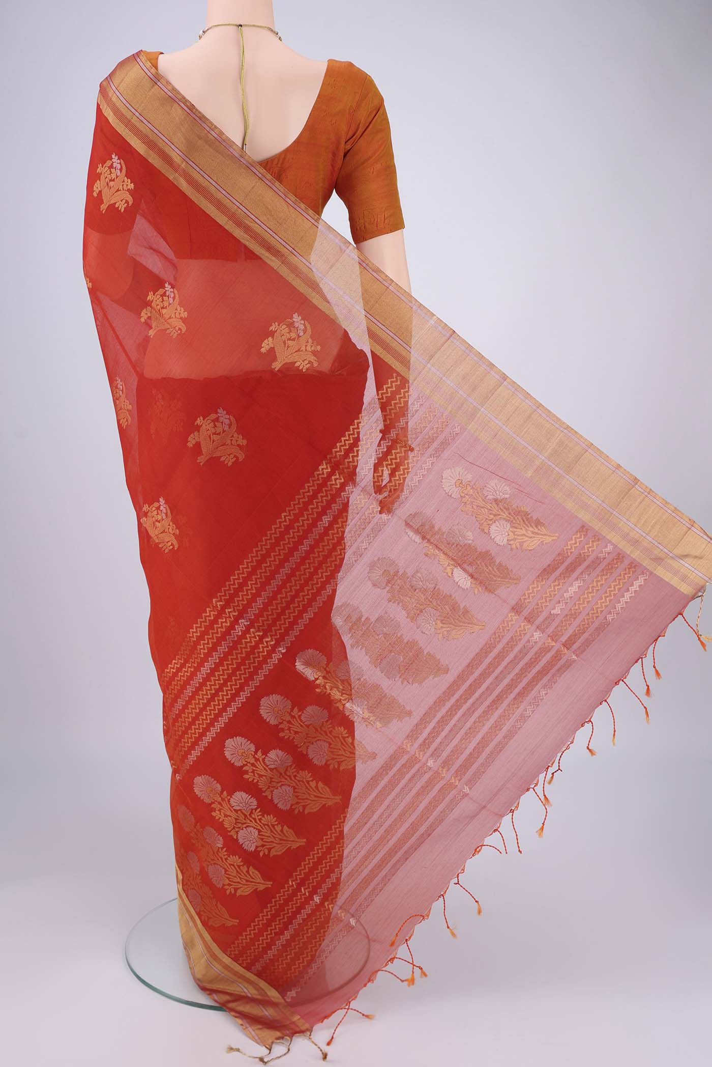 Flat view of Orange Silk Cotton Saree with Zari Butta on the body and Zari Border. 