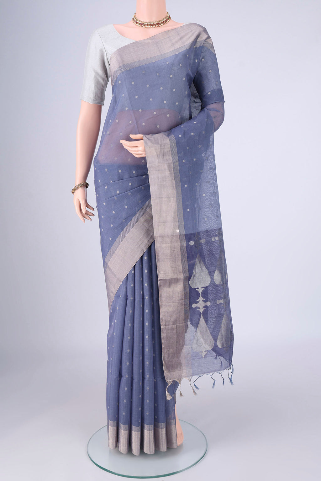 Lilac Silk Cotton Saree with Zari Butta on the body and Zari Border.  displayed on a mannequin
