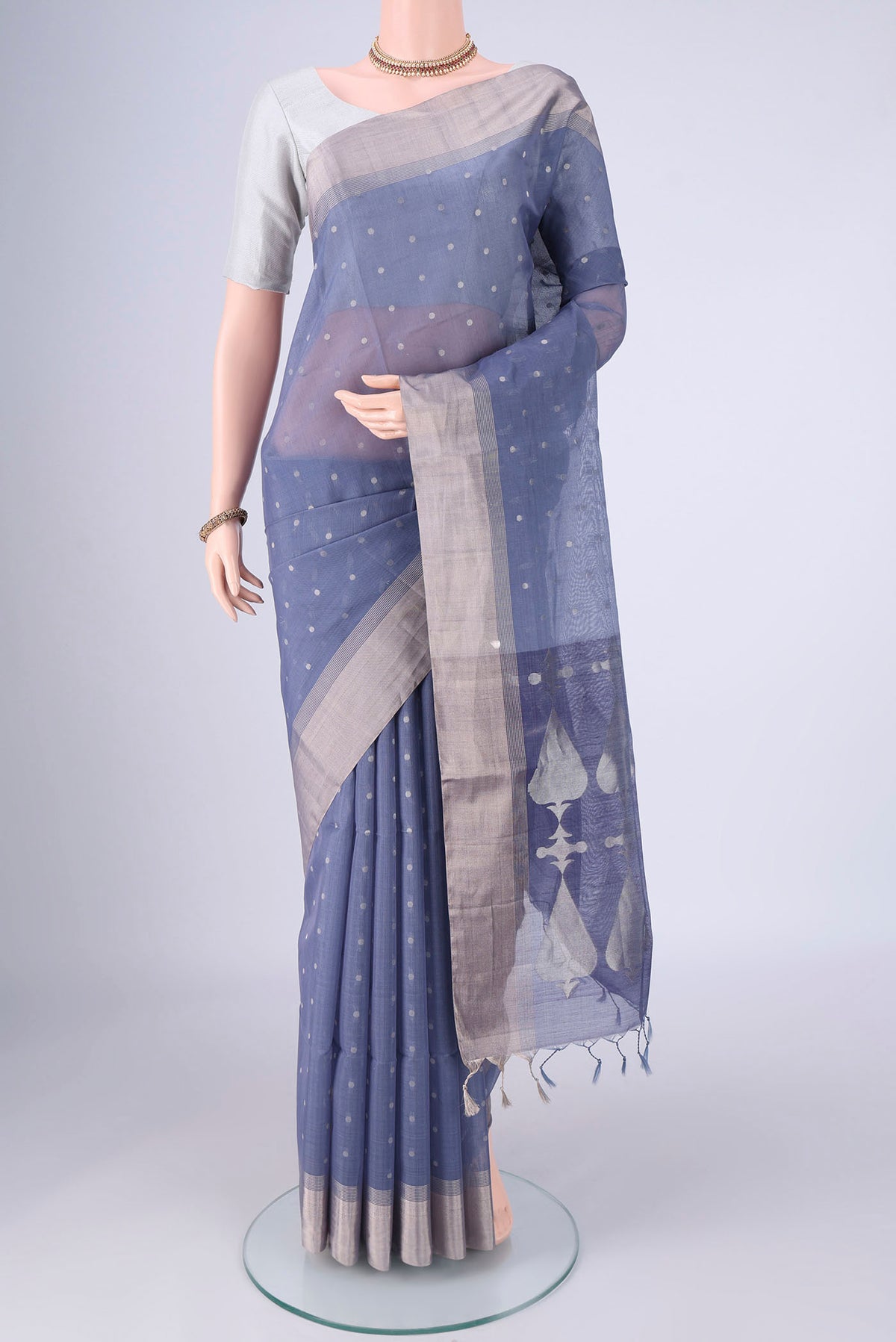 Lilac Silk Cotton Saree with Zari Butta on the body and Zari Border.  displayed on a mannequin