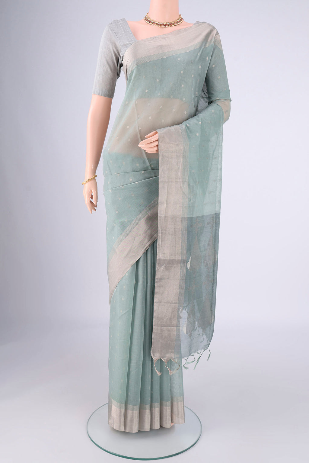 Grey Silk Cotton Saree with Zari Butta on the body and Zari Border.  displayed on a mannequin