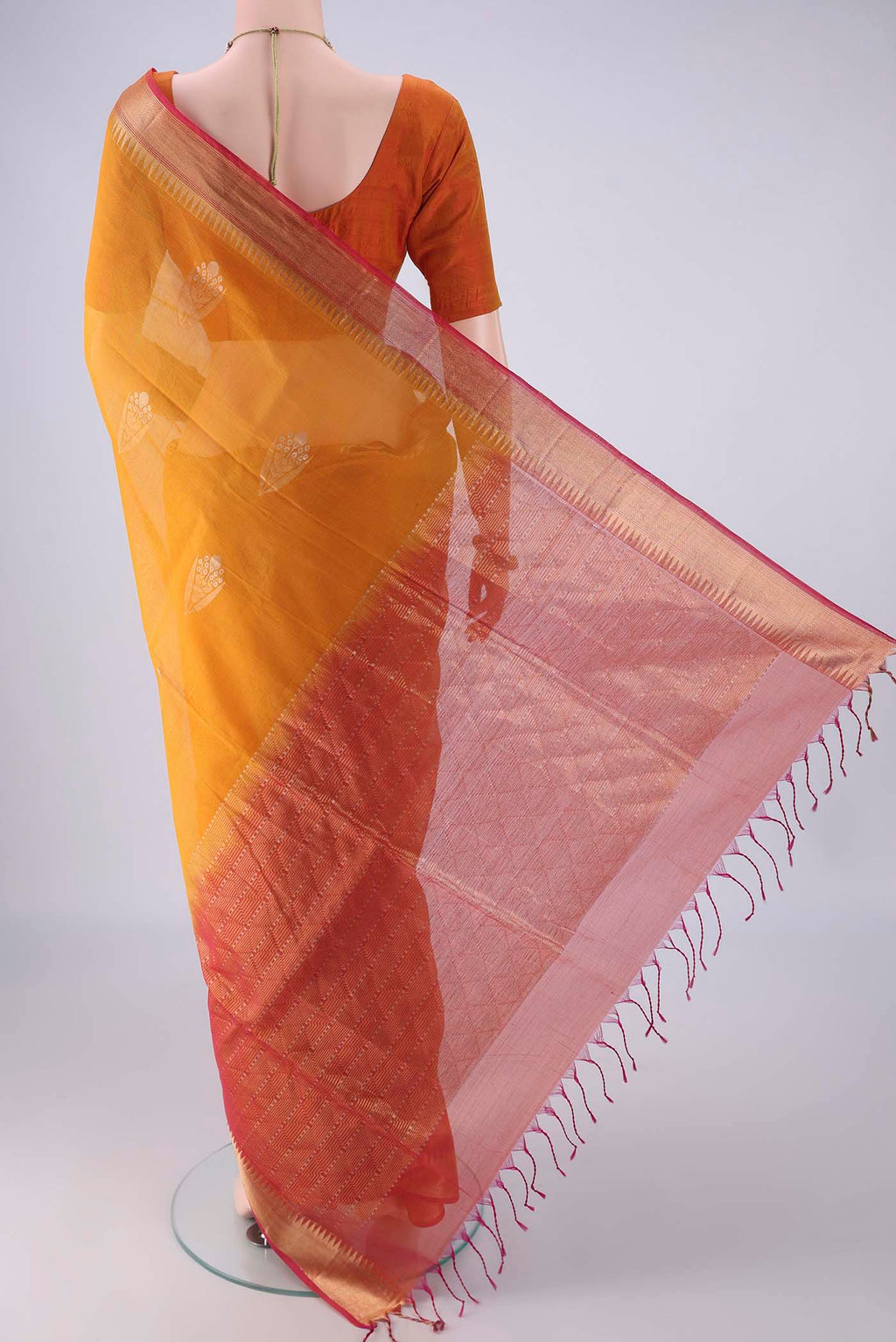 Flat view of Mustard Kora Cotton Saree with Zari Butta on the body and Zari Border. 